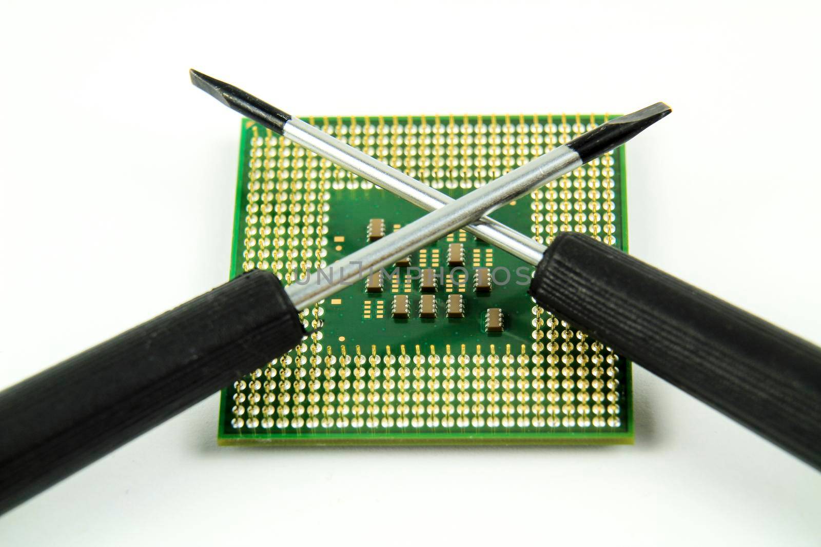 Old and vintage micro processor and screwdriver on white background