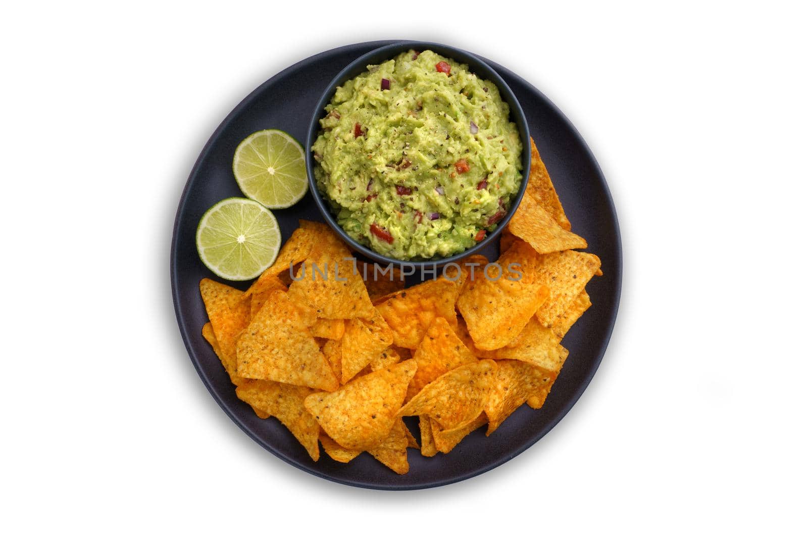 Top view of guacamole dip in black plate with tortilla chips or nachos isolated on a white background. High quality photo