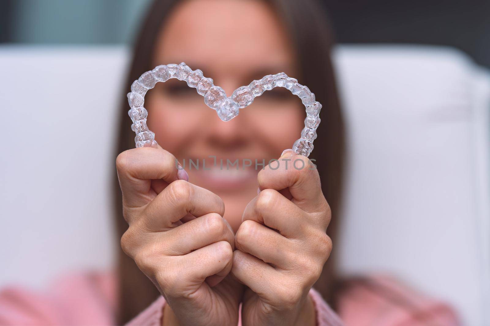 Woman with dental invisible invisalign braces or silicone trainer. Aligners treatment by DariaKulkova