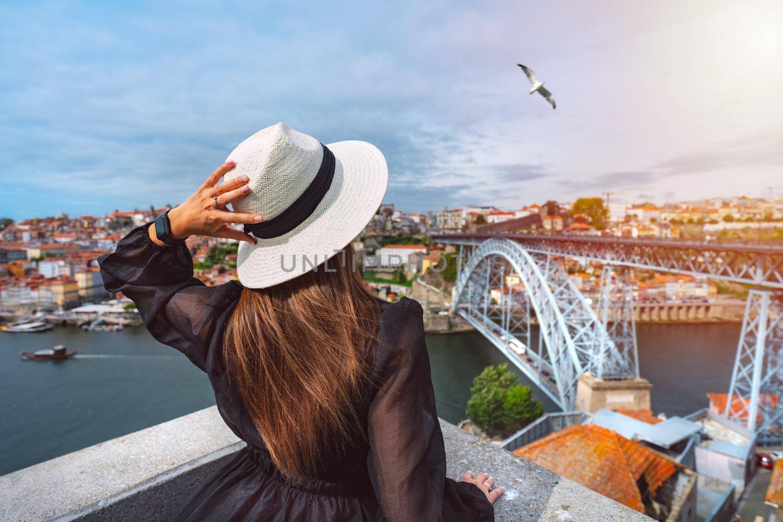 Woman tourist enjoying beautiful view of Porto city and famous Dom Luis I Bridge. Summer holiday vacation in Portugal. by DariaKulkova