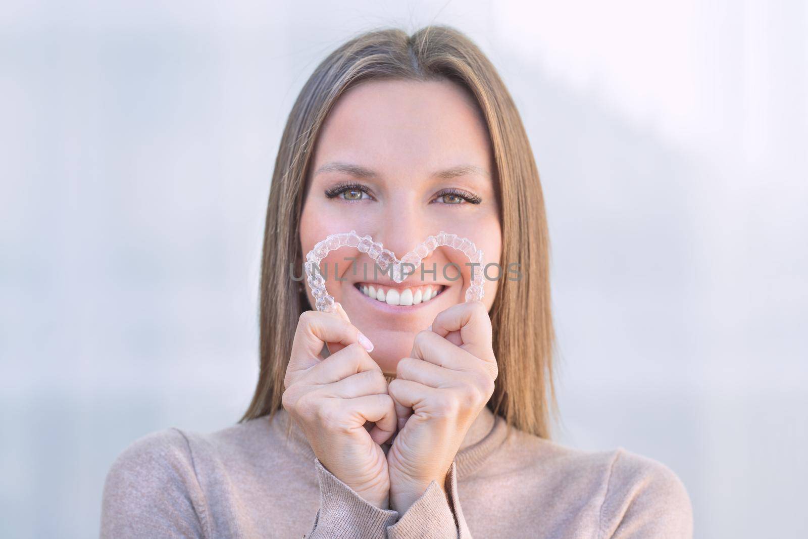 Woman with perfect smile after invisible dental aligners aligners treatment by DariaKulkova