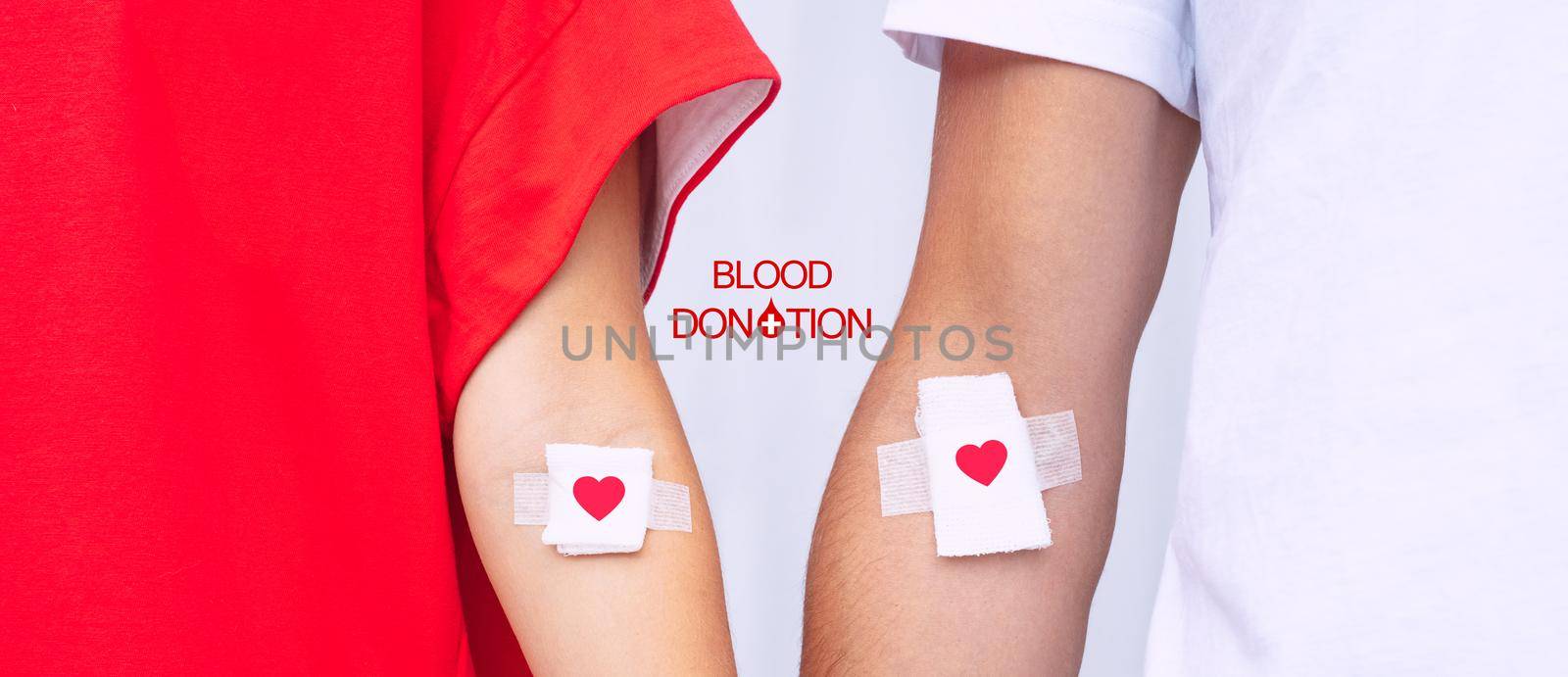 Blood donors with bandage after giving blood. Blood donation, save lives. World blood donor day concept. High quality photo