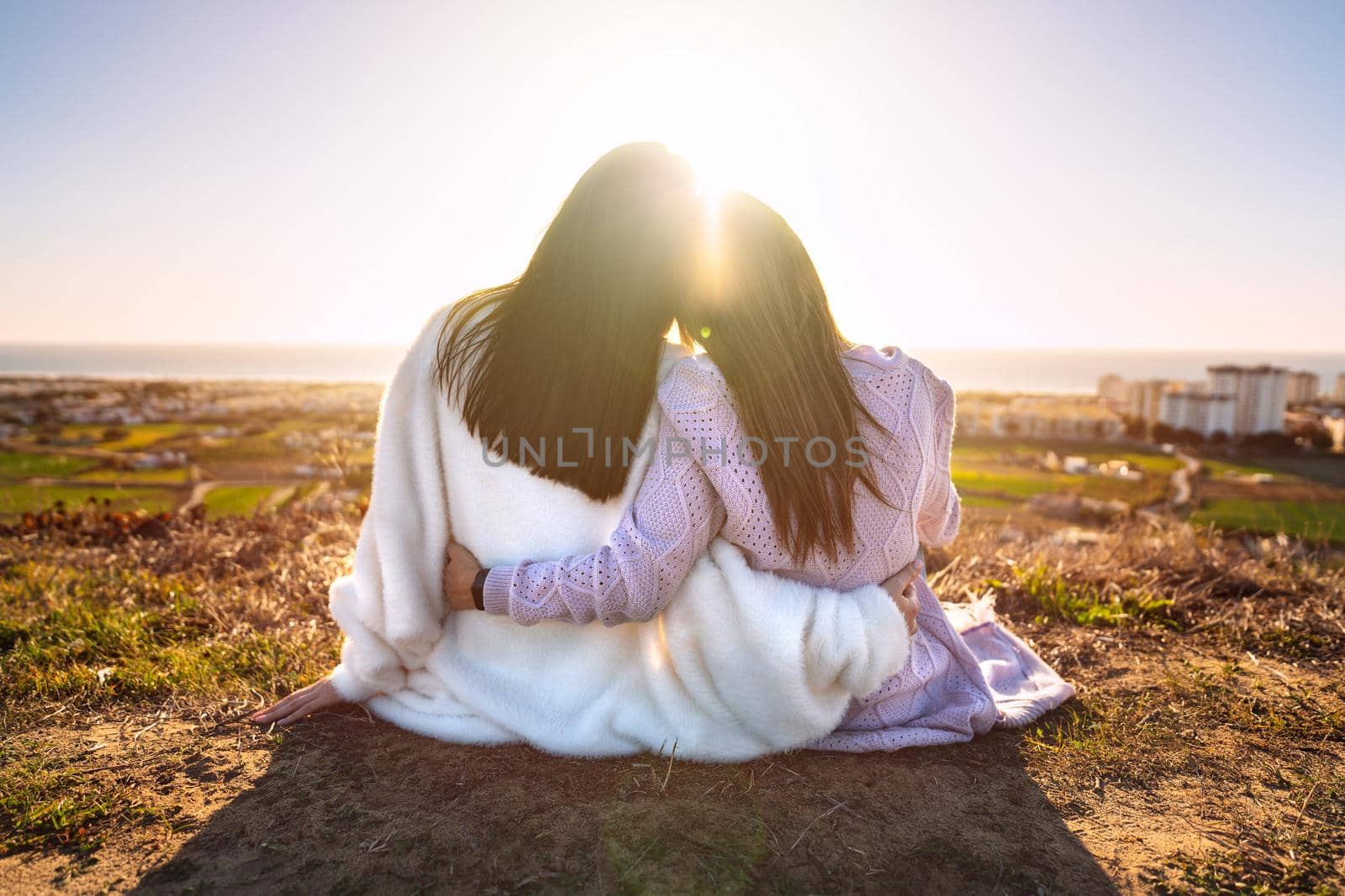 Two best girlfriends or sisters hugging and enjoying life at sunset. Friends spending time together. Friends forever by DariaKulkova