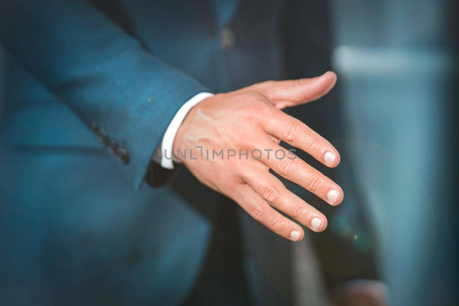 Businessman giving his hand for handshake. Greeting, business offer, partnership or invitation. Collaboration proposal or partner concept. High quality photo