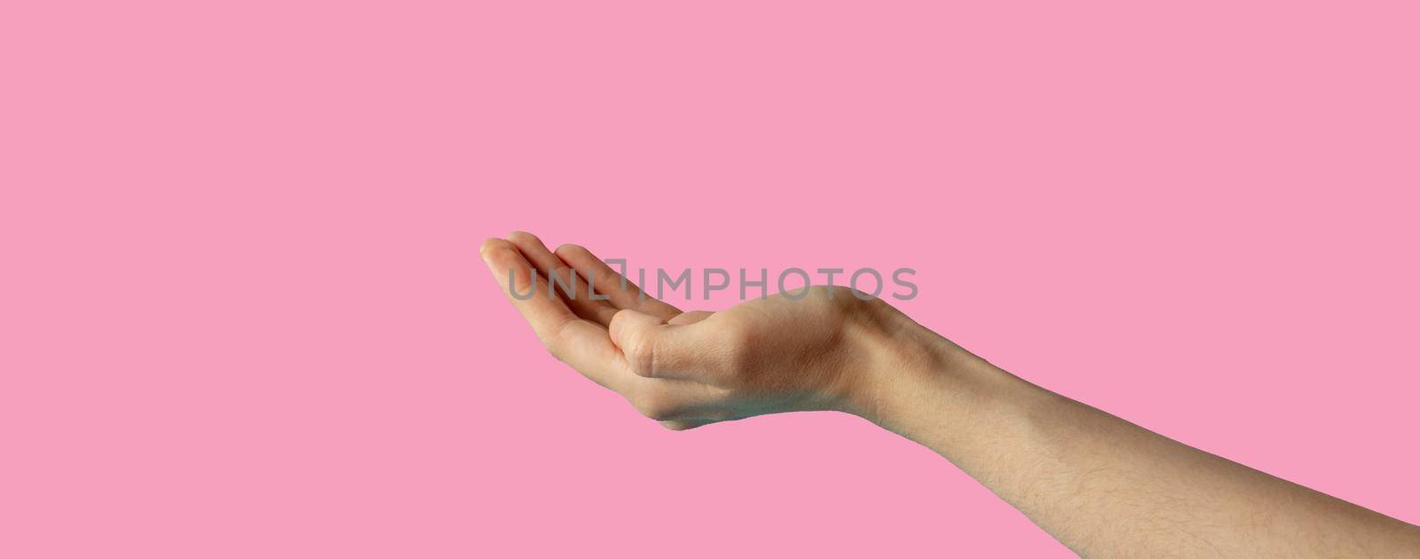 The hand is extended palm up.The hand is open and ready to help or accept. A gesture highlighted on a pink background with a clipping outline by lapushka62