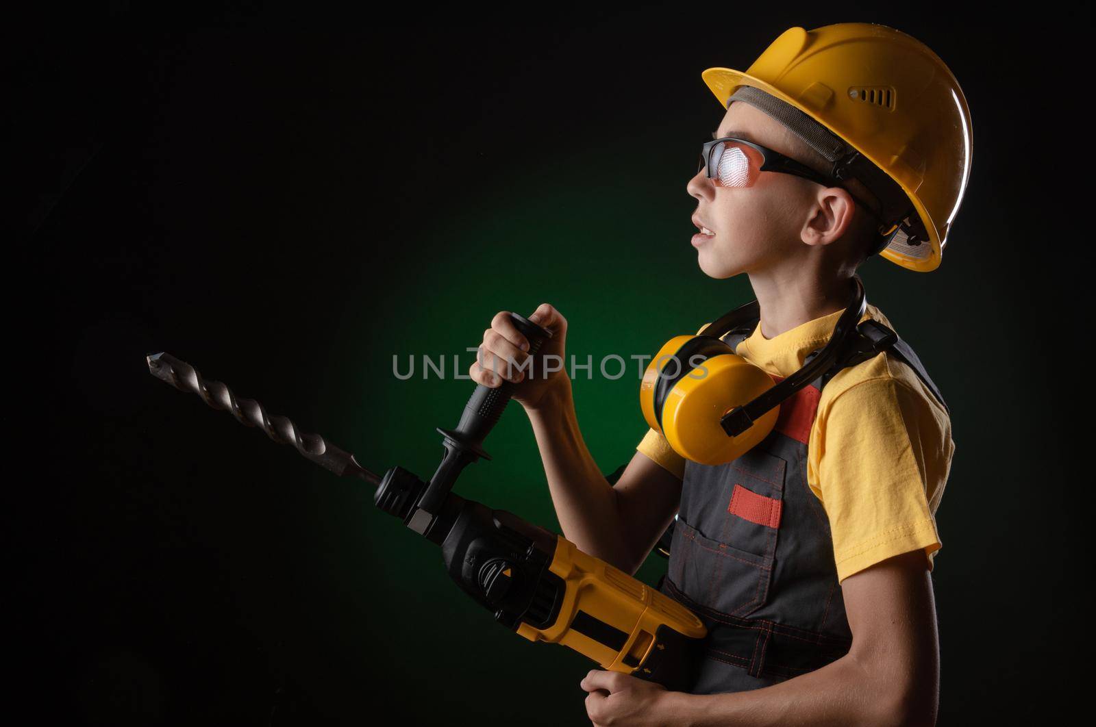 child the Builder costume posing with a work tool