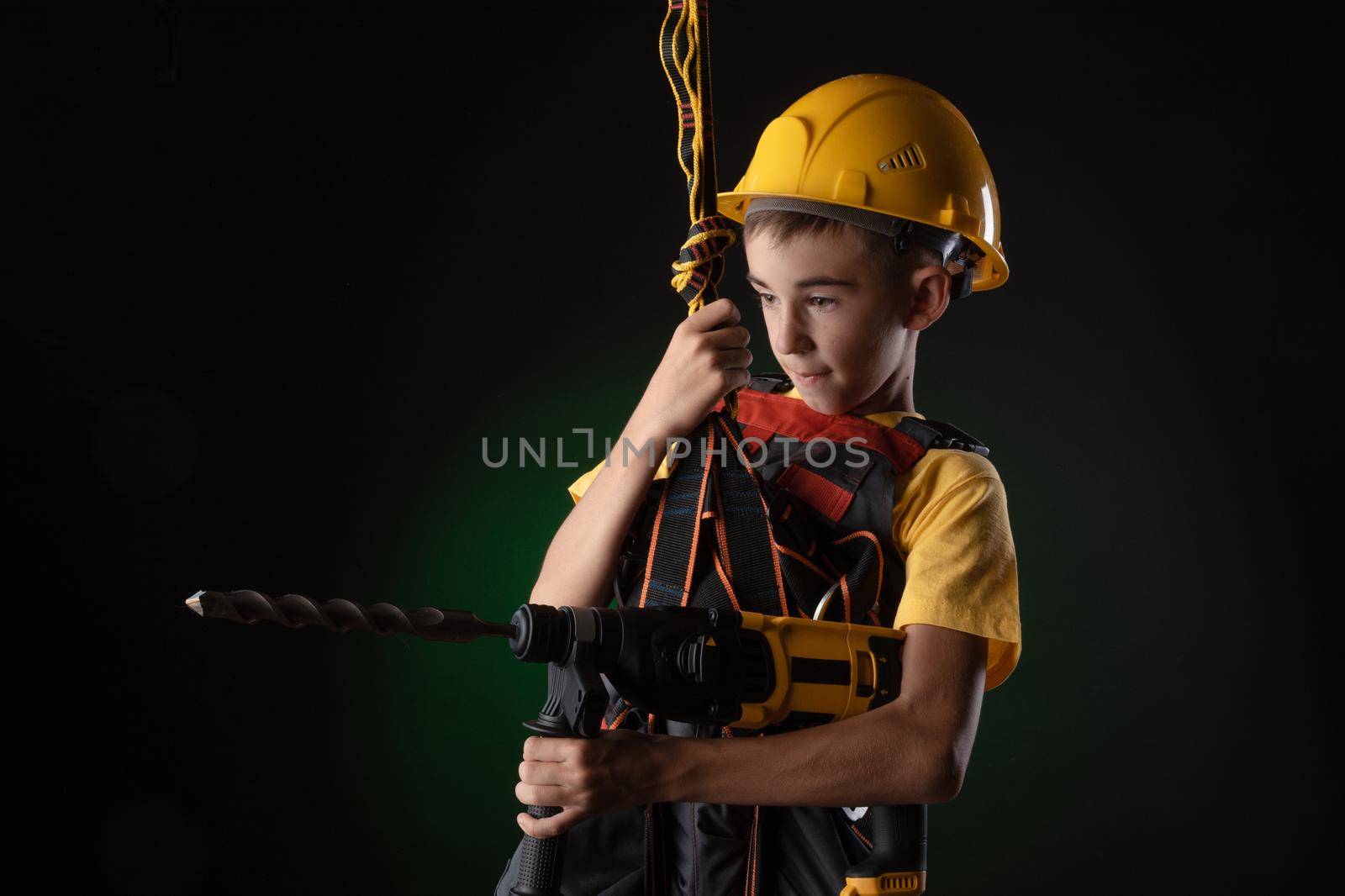 the child the Builder costume posing with a work tool