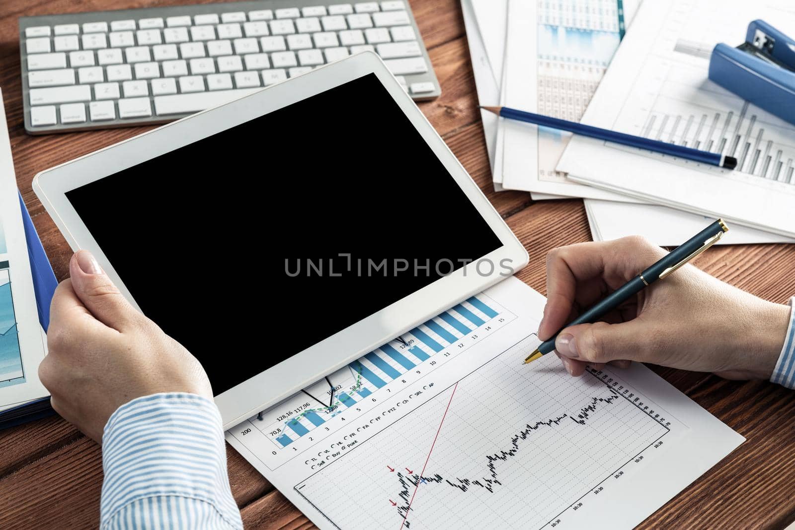 close-up, female hands with tablet. Business woman working at the table in the office