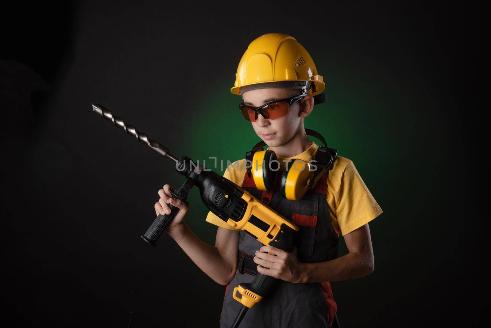 child the Builder costume posing with a work tool