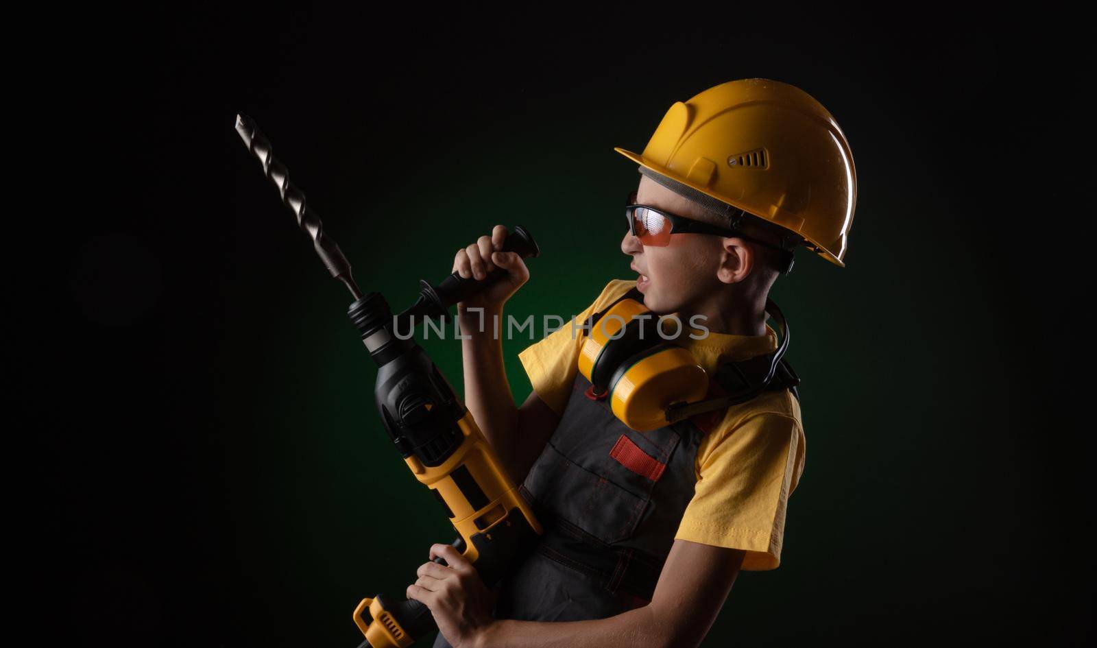 child the Builder costume posing with a work tool