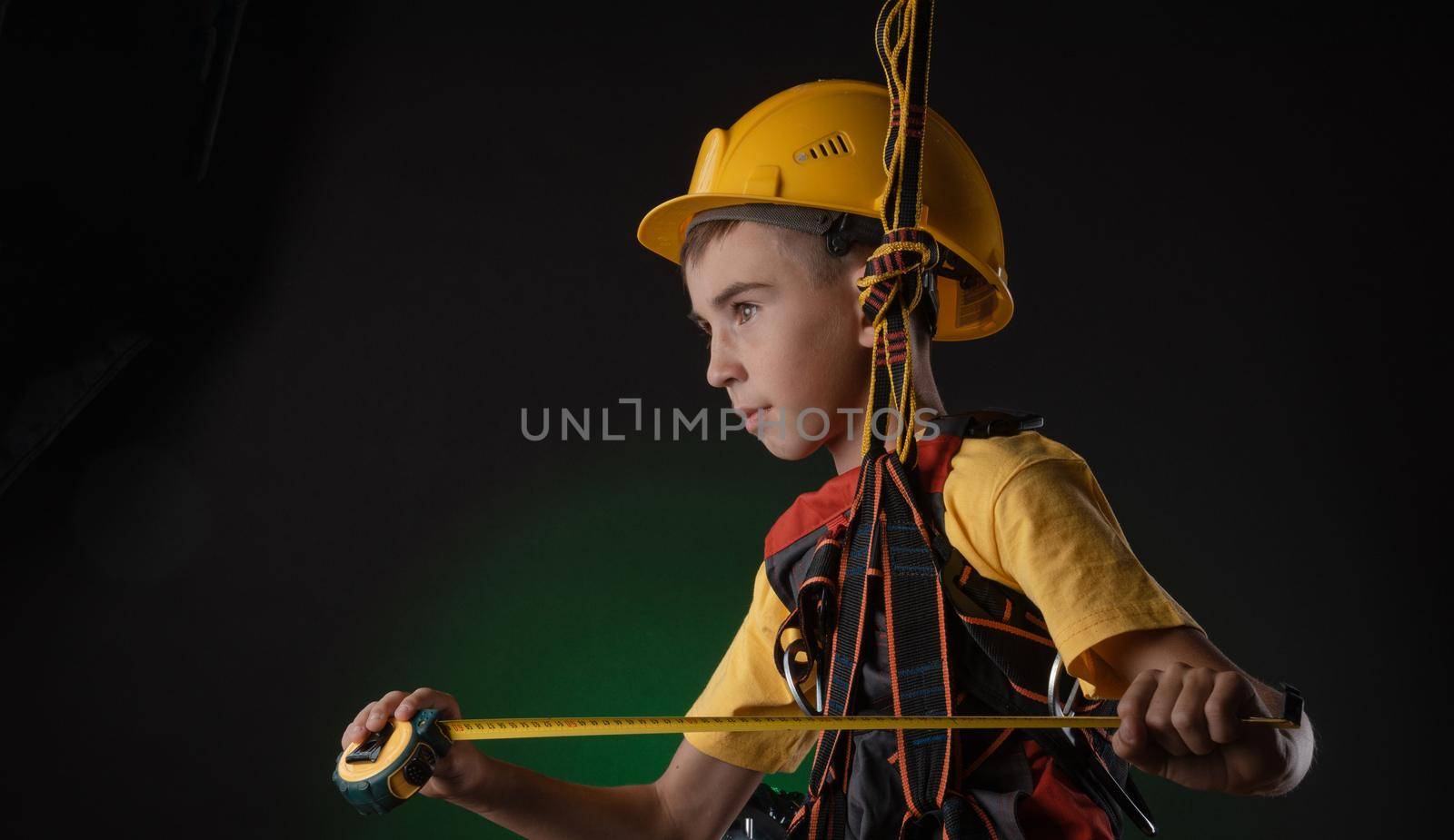 the child the Builder costume posing with a work tool