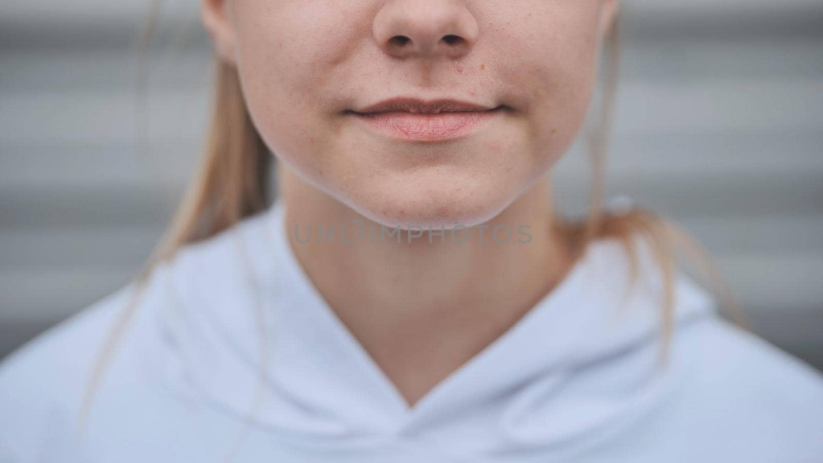 Portrait of a blonde teenage girl. Lips close-up. by DovidPro