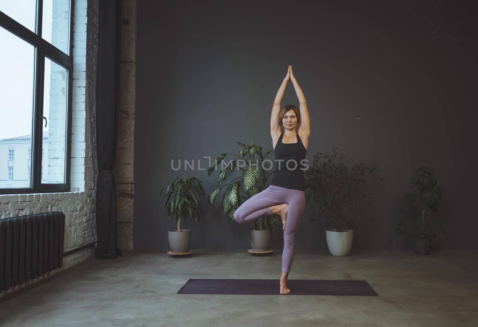 Body conscious. Human body, physical position, well being concept. Yoga, young woman stands in an asana. High quality photo
