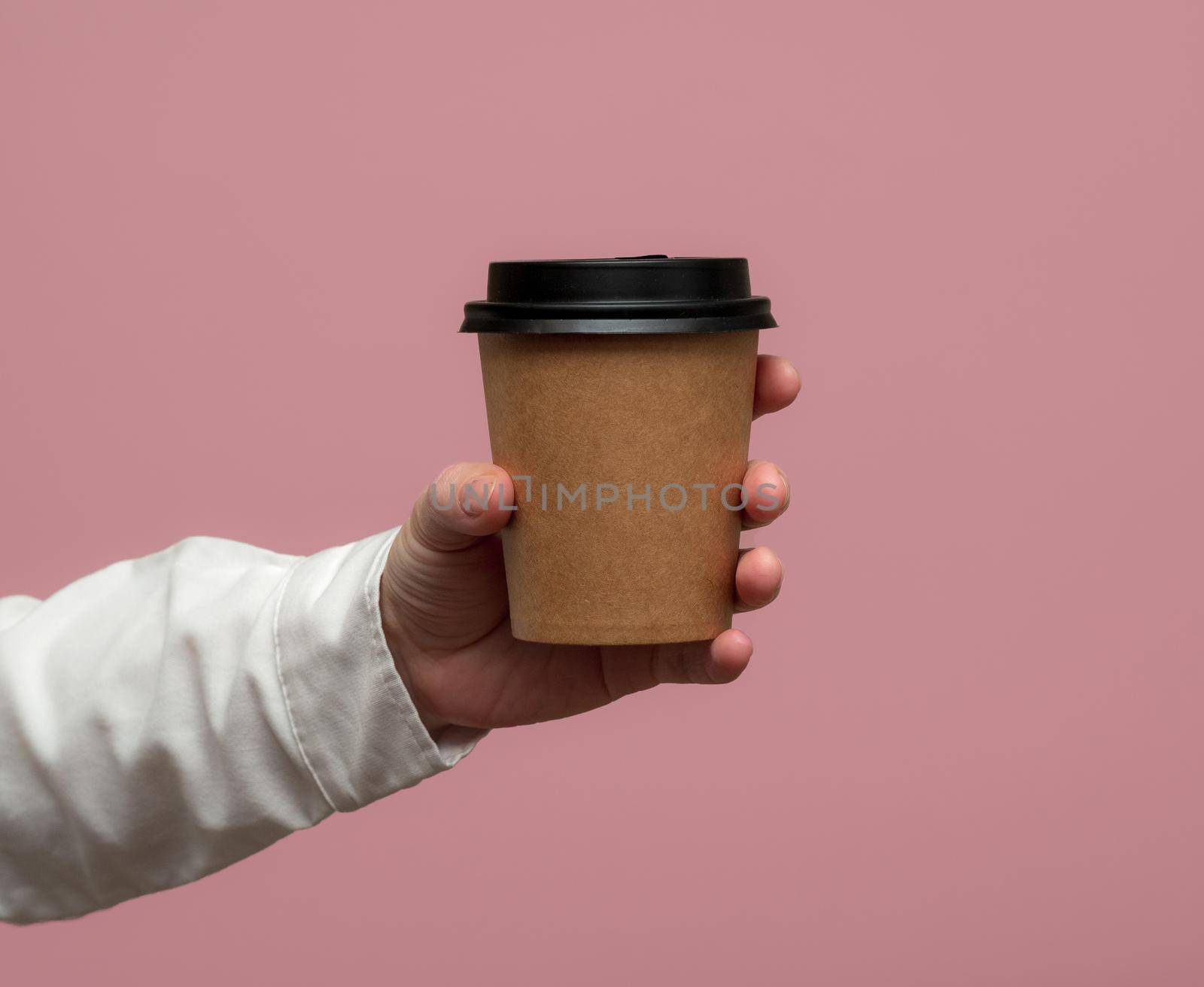 disposable cup of coffee in hand. Mockup.