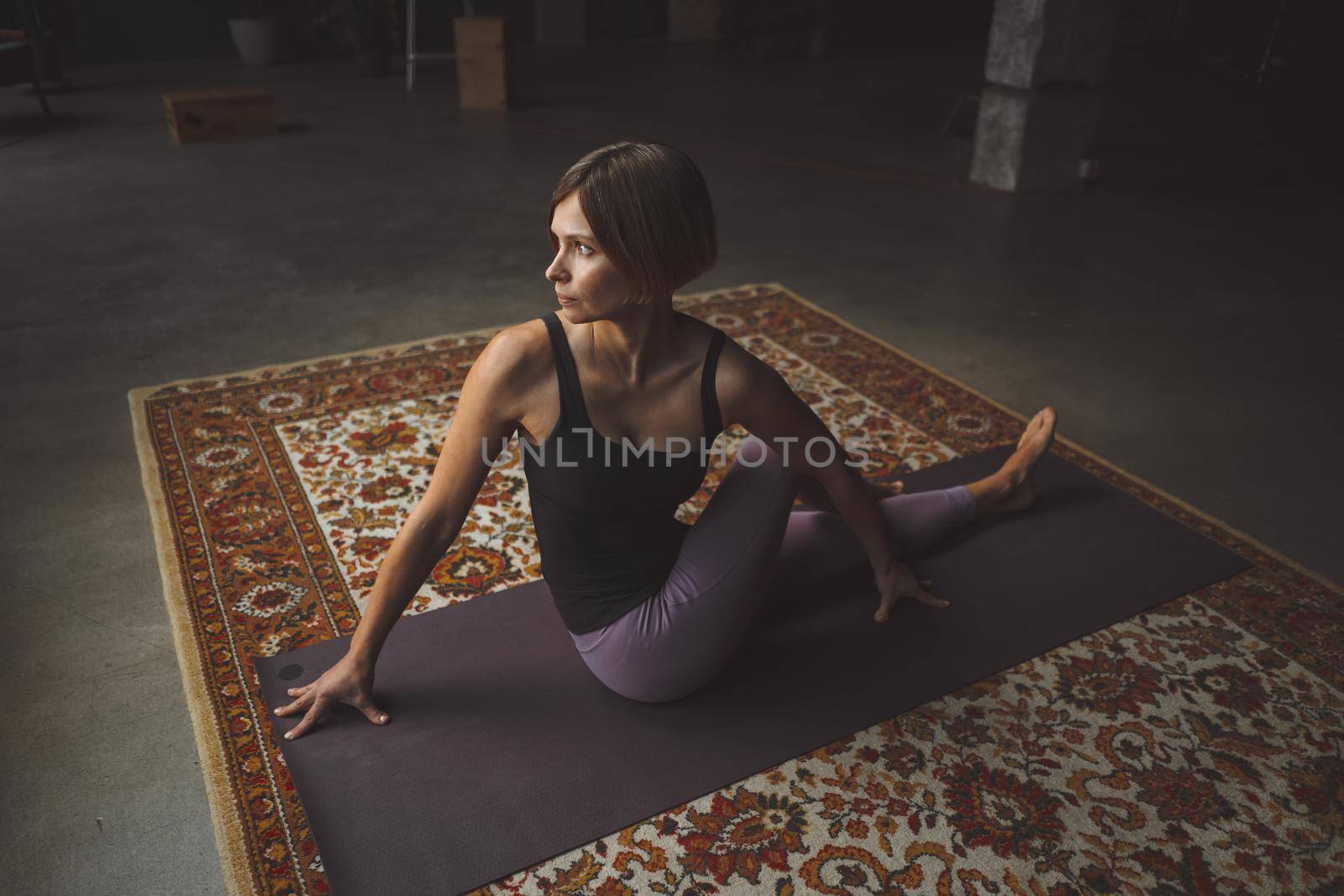 Yogi Female Practicing Yoga Pose on Mat in Vintage Living Room, Paripurna Navasana Exercise, Sport Workout Style, Fitness at Home, Healthy Lifestyle. Close-up. High quality photo