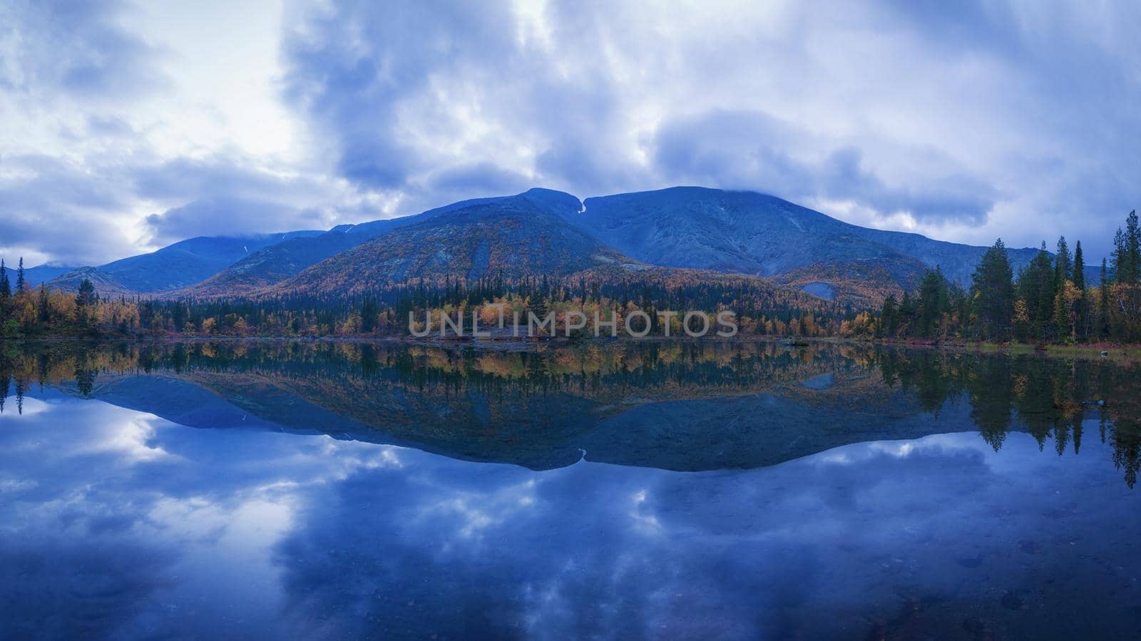 Reflection of sunset clouds in a lake in the Khibiny mountains.