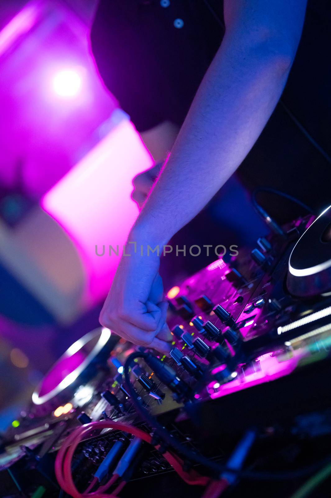 Dj mixing at party festival with light and smoke in background - Summer nightlife view of disco club inside. by HERRAEZ
