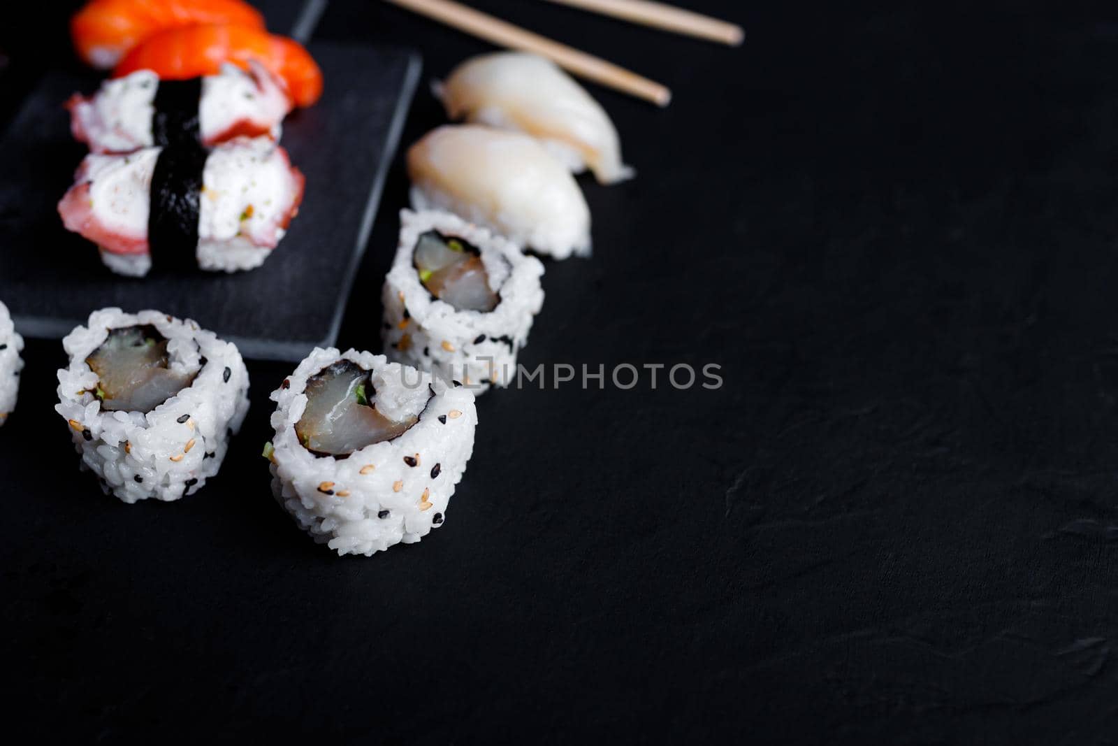 japanese sushi food. Maki ands rolls with tuna, salmon, shrimp, crab and avocado. Top view of assorted sushi. by lifesummerlin