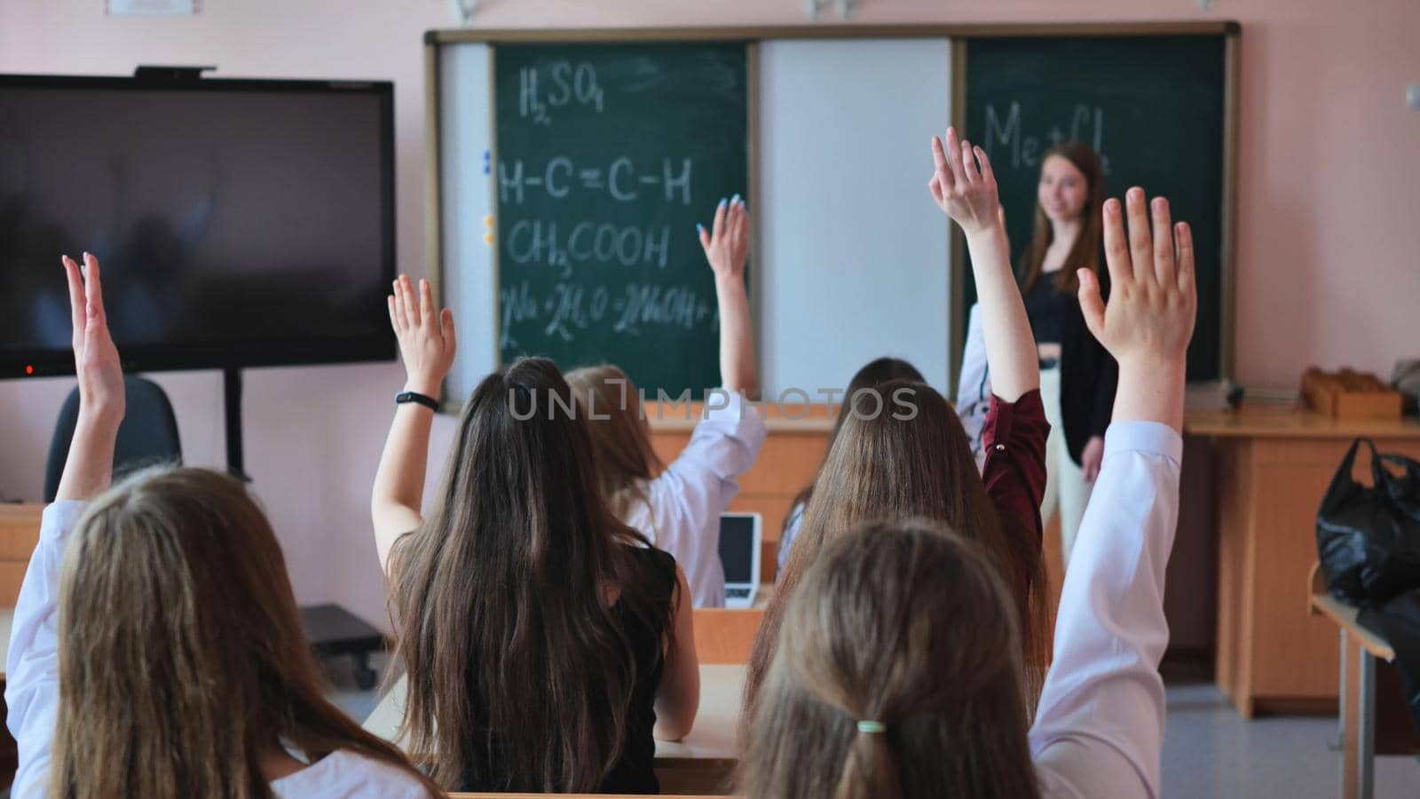 High school students stretch their hands in the lesson. Russian school. by DovidPro