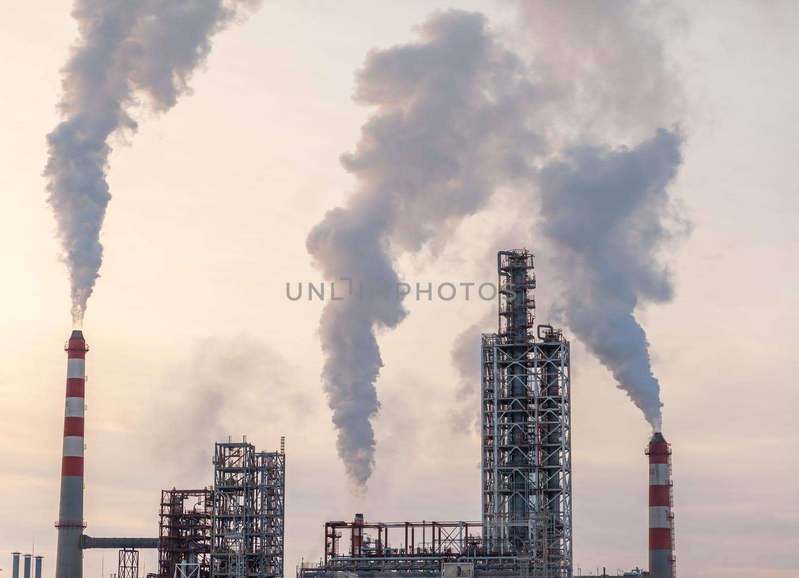 The work of a petrochemical plant. Smoke is coming from the chimney. by AnatoliiFoto
