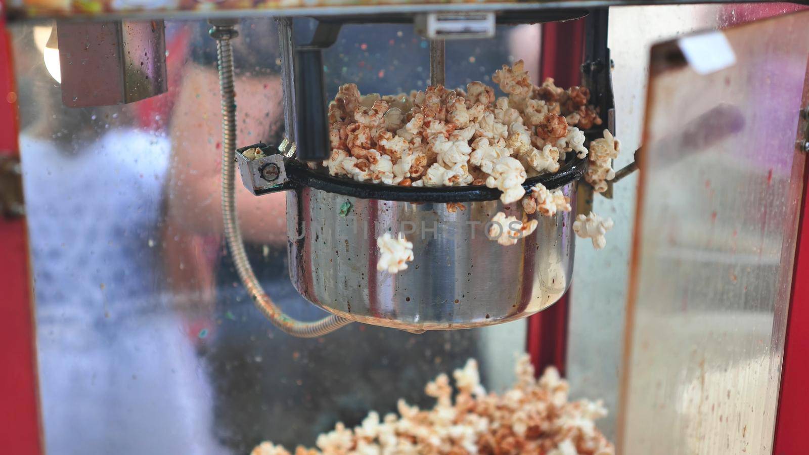 Cooking tasty colorful popcorn on the street. by DovidPro