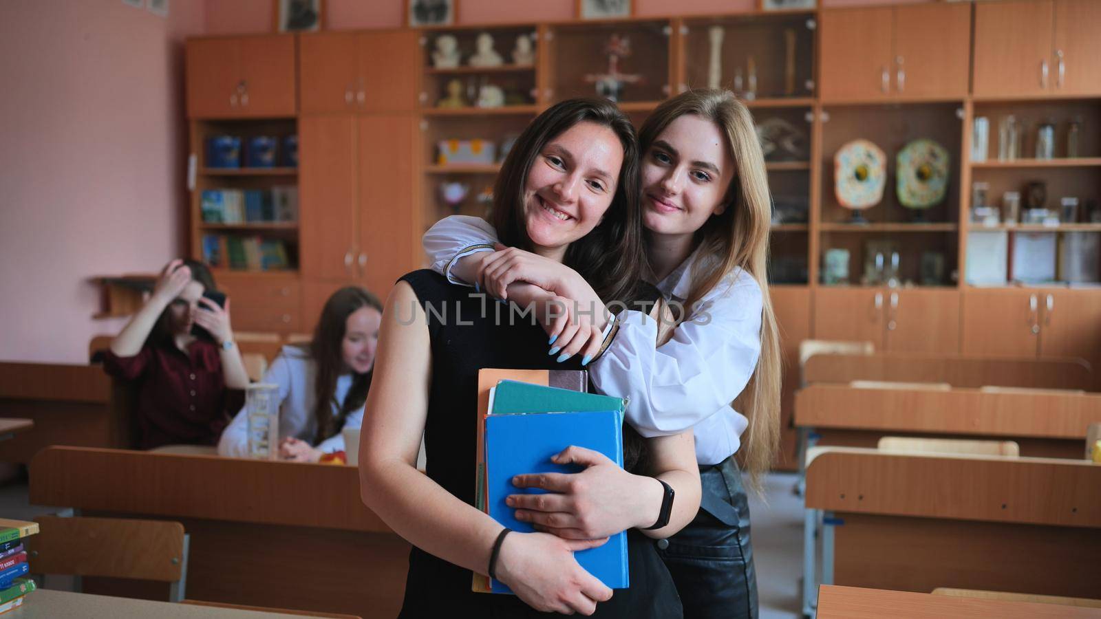 Beautiful female students are posing in the class. by DovidPro