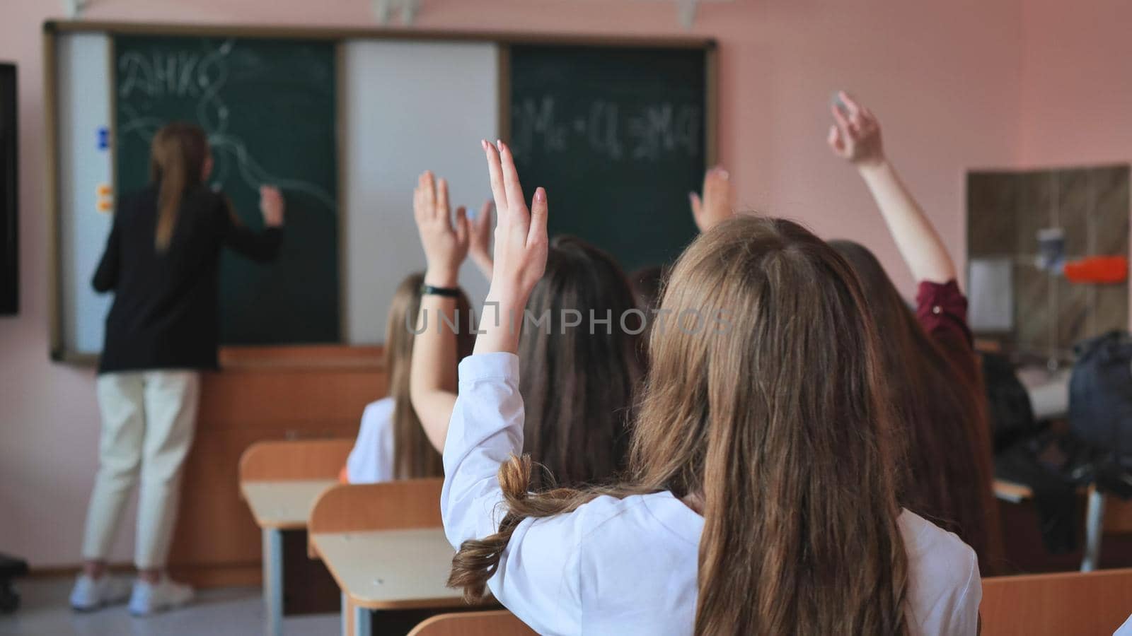 High school students stretch their hands in the lesson. Russian school. by DovidPro