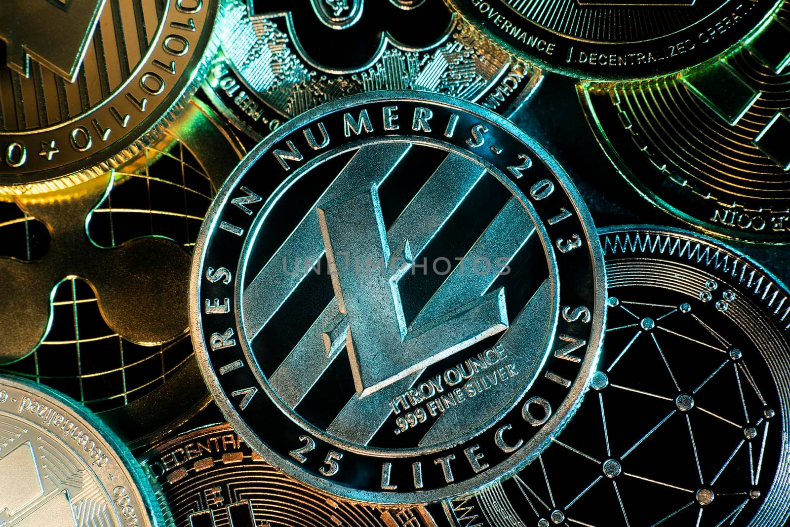 Horizontal view of cryptocurrency tokens, including Litecoin, Bitcoin, dogecoin, and ethererum saw from above on a black background. flat lay by avirozen