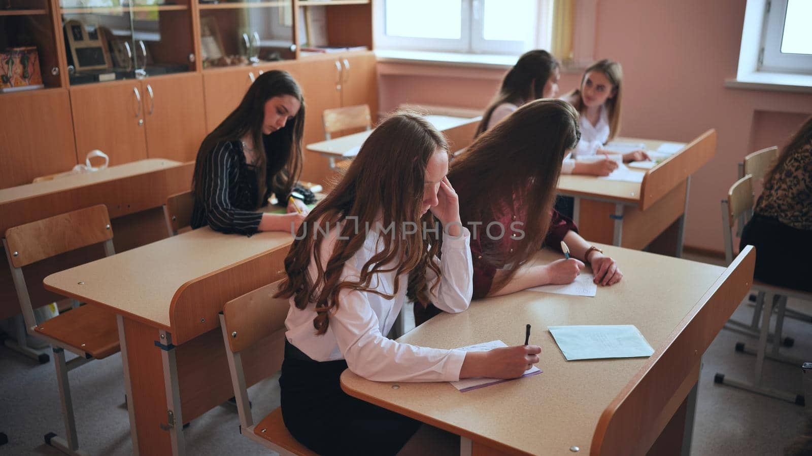 Pupils of the 11th grade in the class at the desks during the lesson. Russian school. by DovidPro