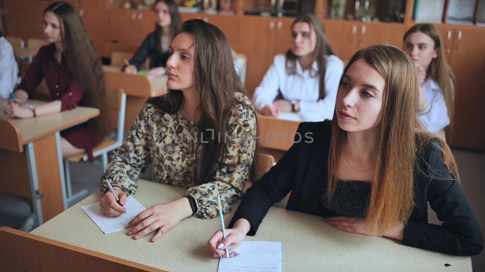 Pupils of the 11th grade in the class at the desks during the lesson. Russian school. by DovidPro