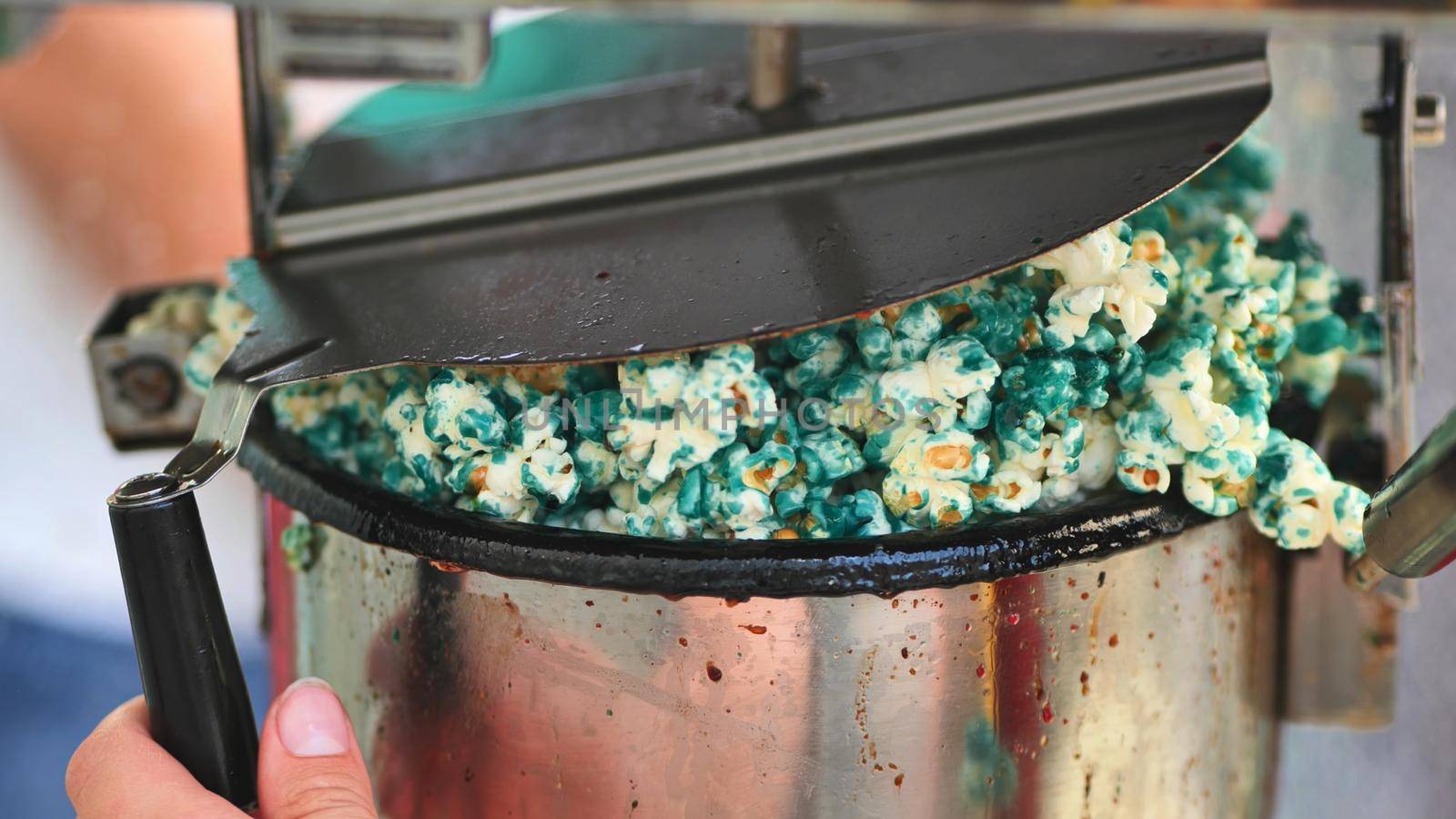 Cooking tasty colorful popcorn on the street. by DovidPro