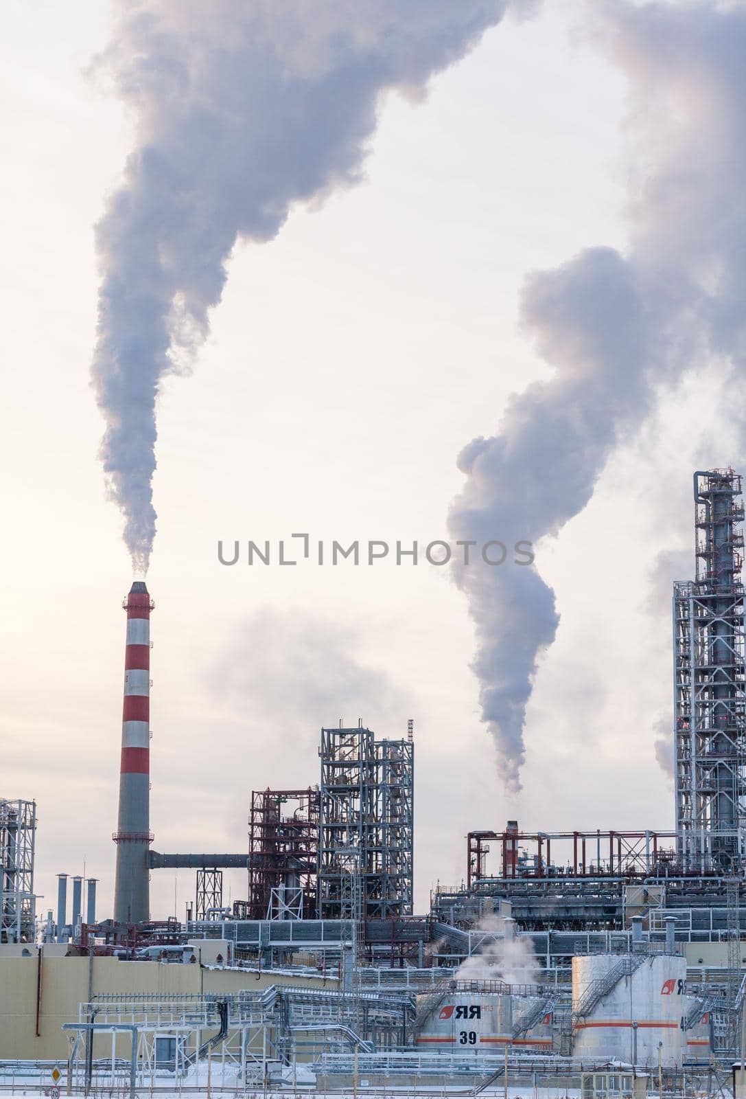 The work of a petrochemical plant. Smoke is coming from the chimney. by AnatoliiFoto