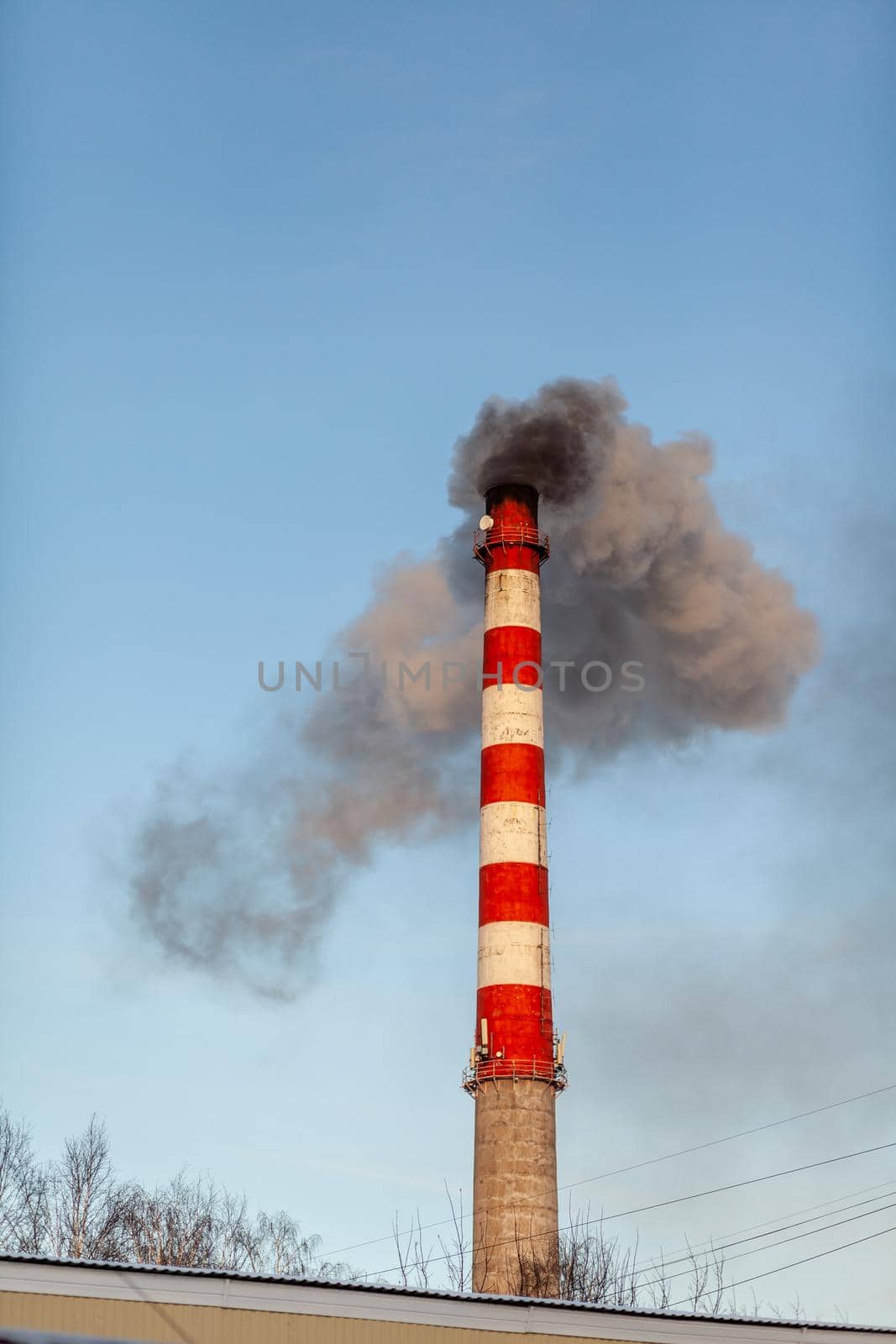 White thick smoke from the boiler room chimney. Industrial zone. by AnatoliiFoto