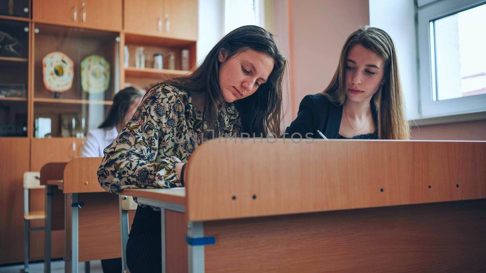 Pupils of the 11th grade in the class at the desks during the lesson. Russian school