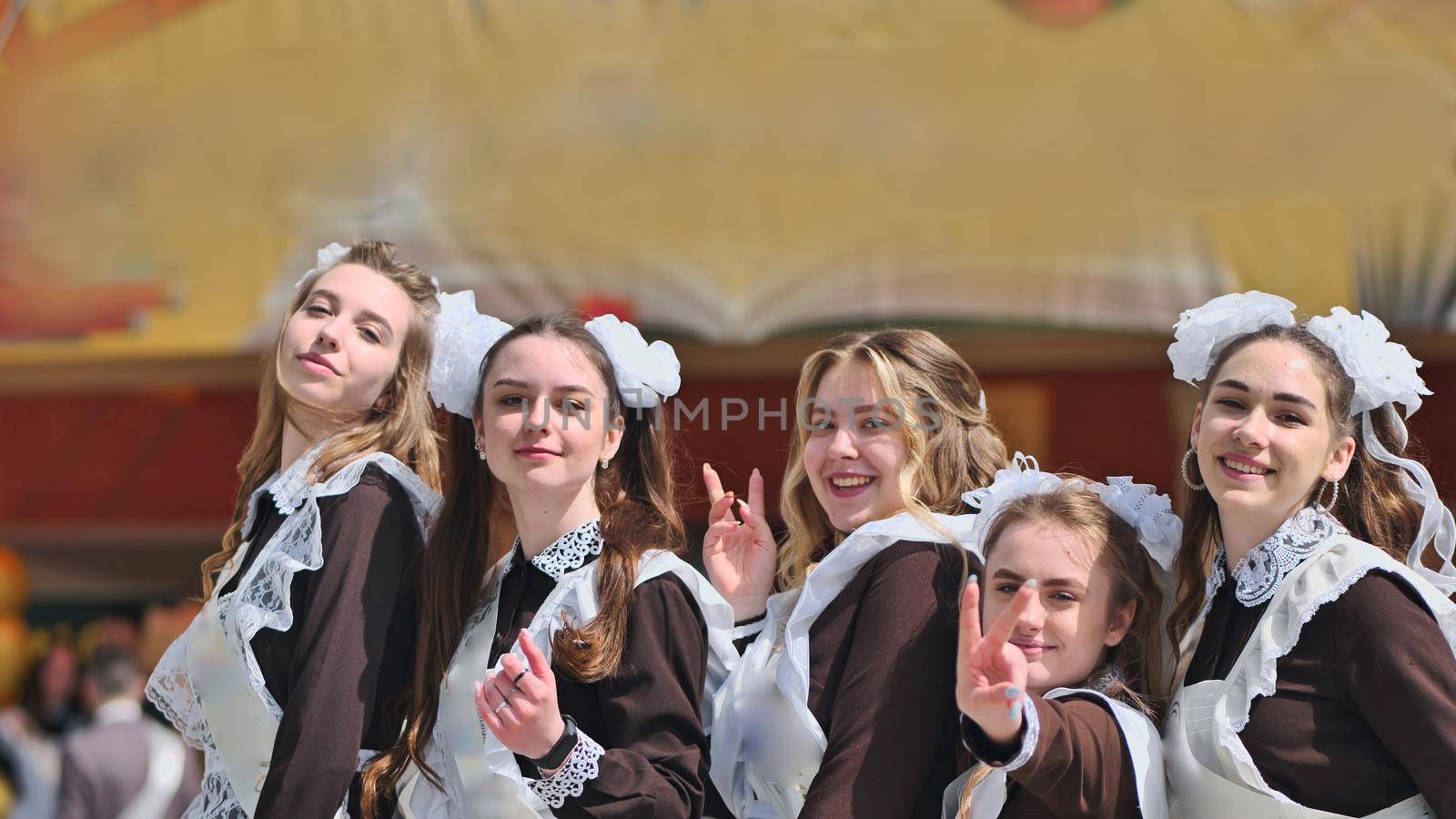 Happy Russian female graduates pose on their graduation day