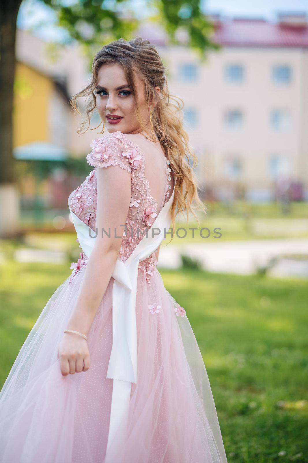 Beautiful schoolgirl in dress at the prom at school. by DovidPro