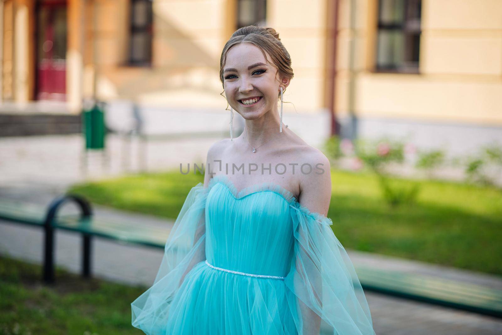 Beautiful schoolgirl in dress at the prom at school. by DovidPro