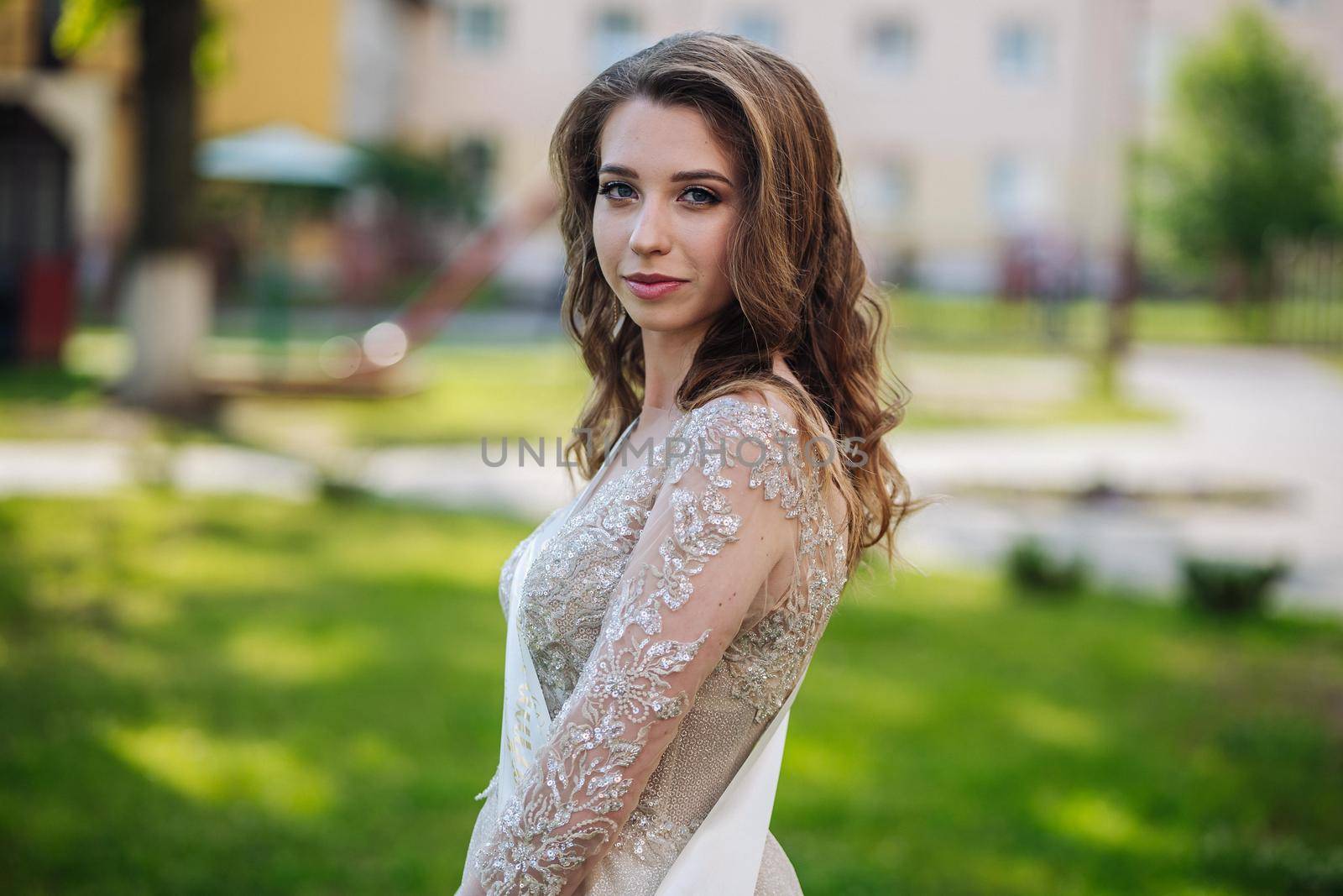 Beautiful schoolgirl in dress at the prom at school