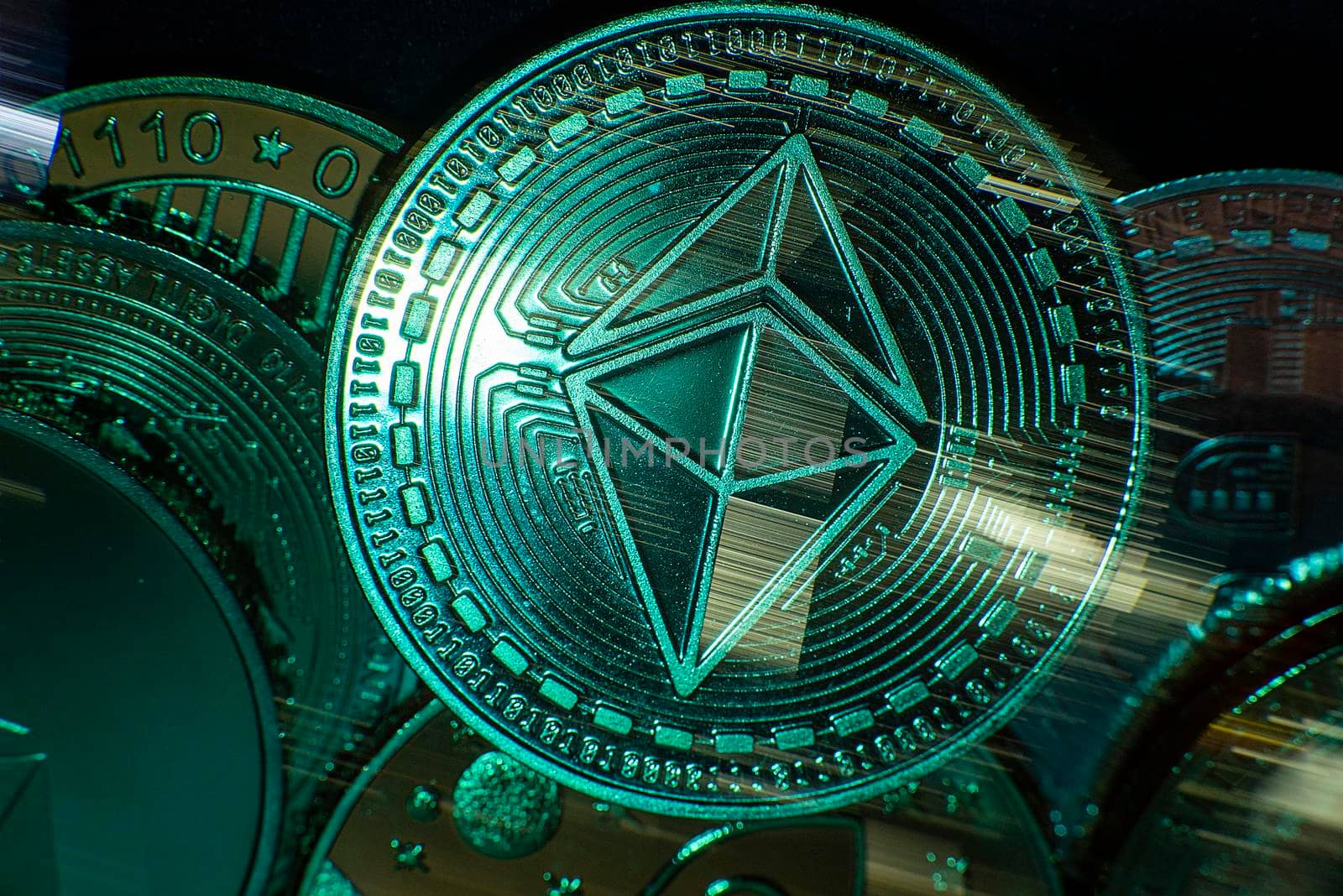 Horizontal view of cryptocurrency tokens including Ethereum seen from above on a black background with light trails. High quality photo