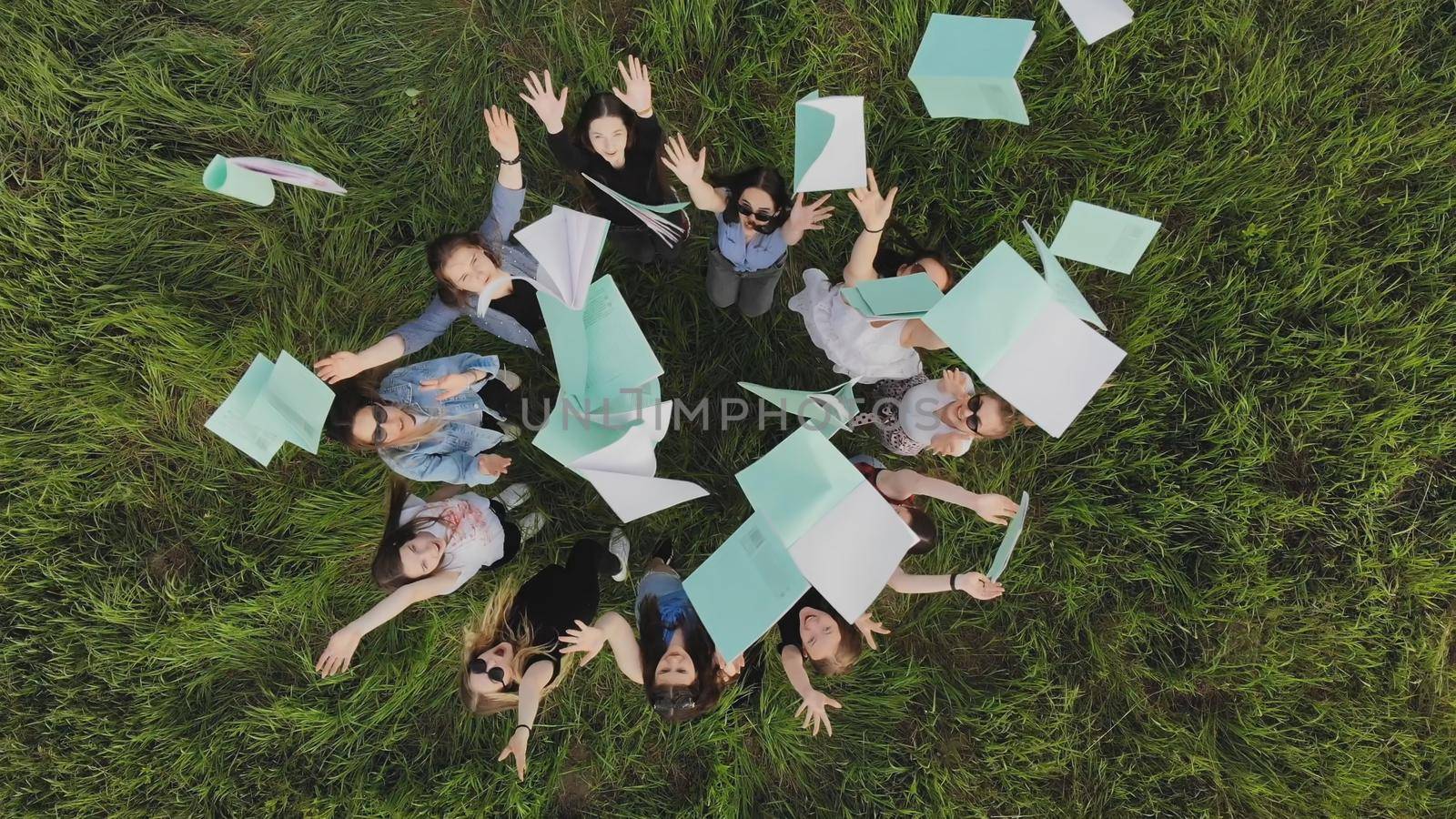 Students toss exercise books on their last day of school. by DovidPro