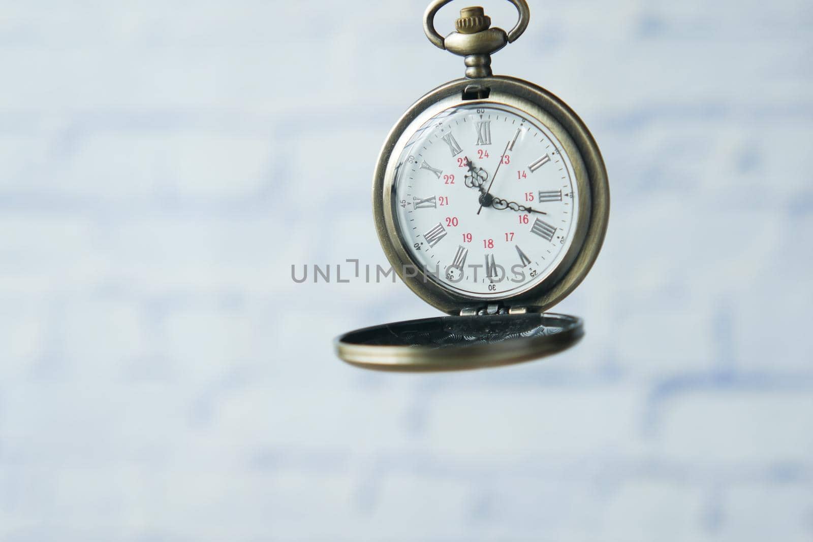 old vintage clock against while wall .