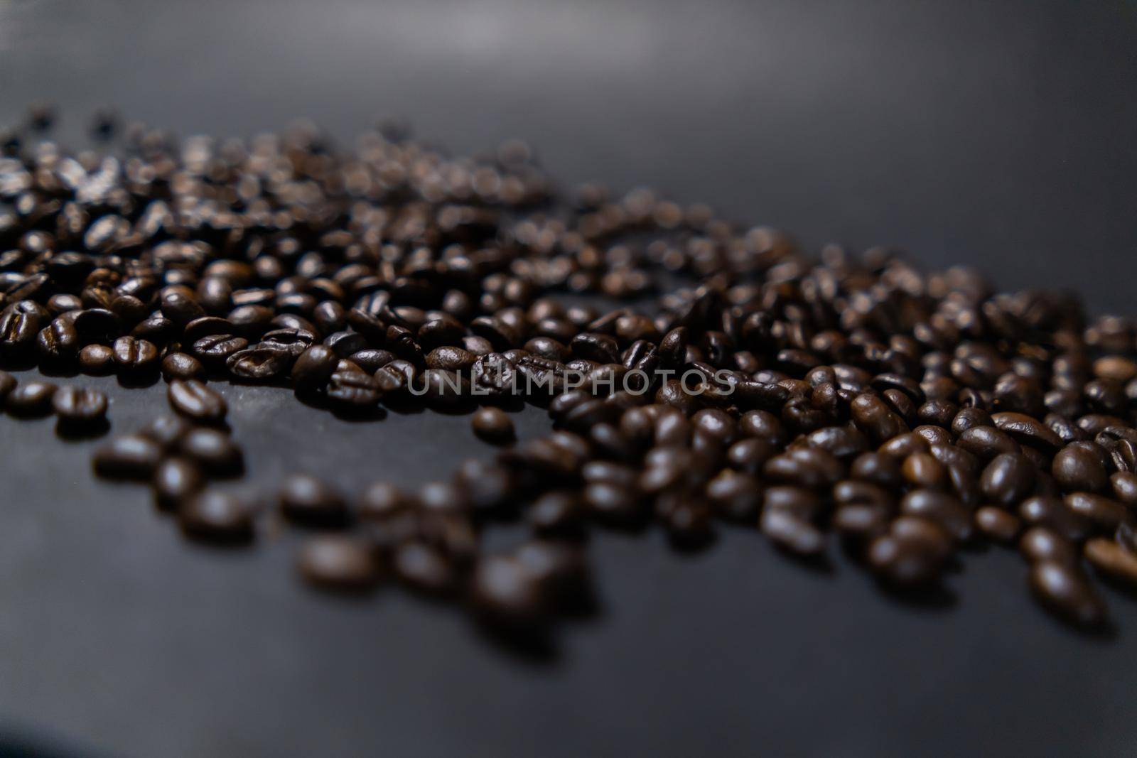 Pile of roasted coffee beans with dark gray background by Kanelbulle