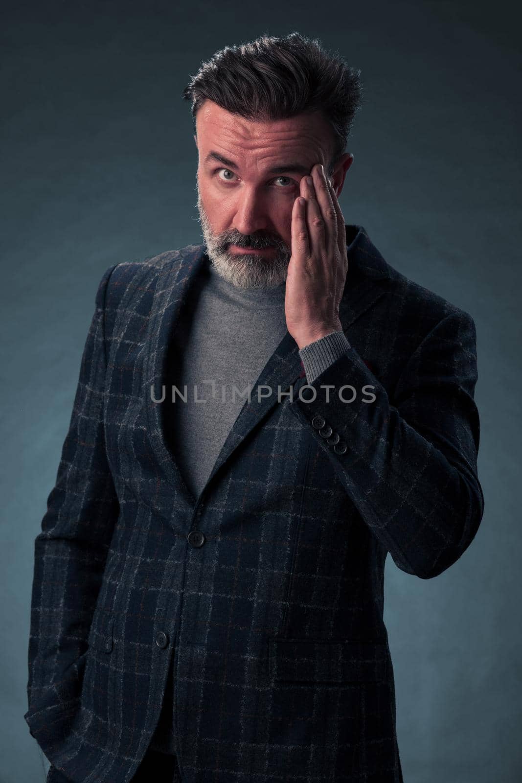 Frustrated middle aged elegant man Close up face of stressed businessman wearing stylish suit with eyes closed. Overworked middle eastern business man with terrible migrain by dotshock