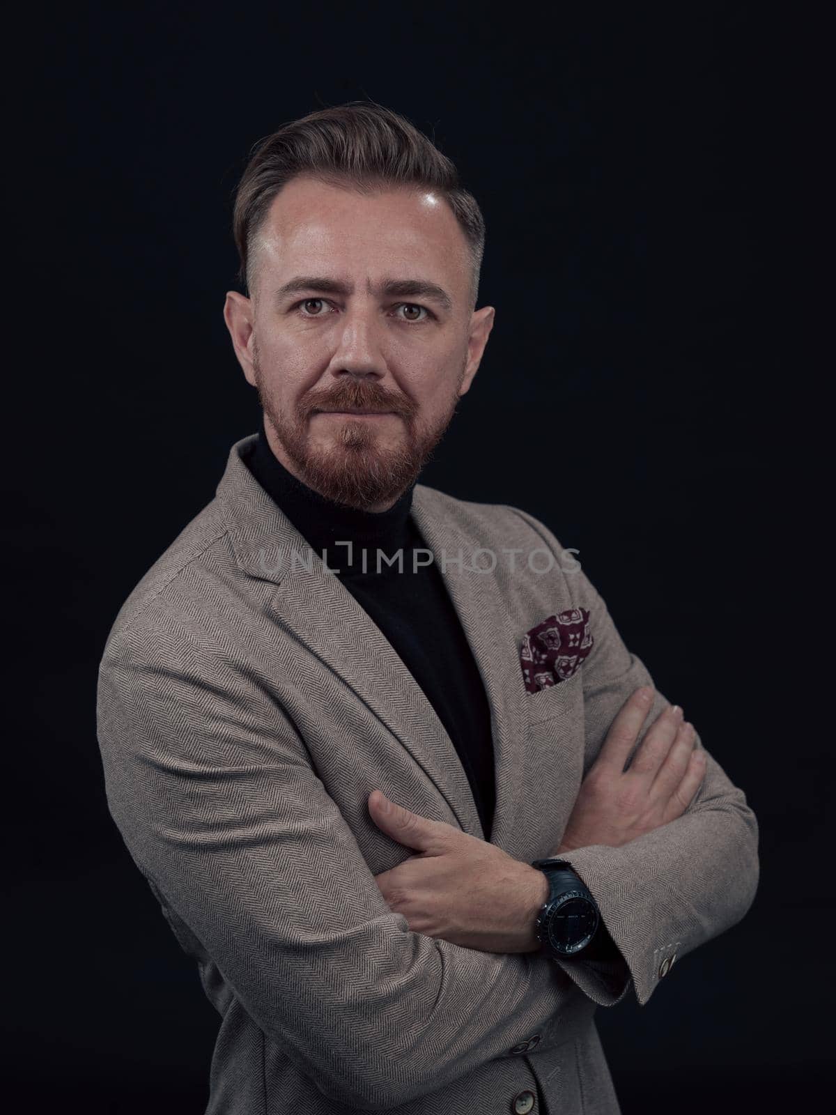 Confident bearded senior businessman man in stylish clothes with his arms crossed isolated over black background by dotshock