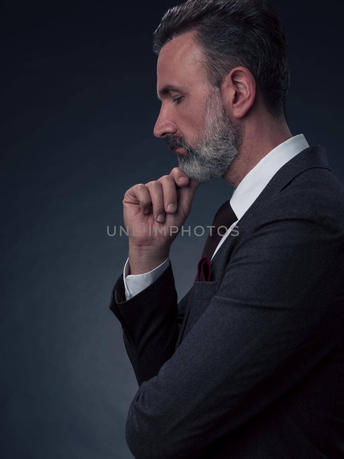 Frustrated middle aged elegant man Close up face of a stressed businessman wearing a stylish suit with eyes closed. Side shot by dotshock