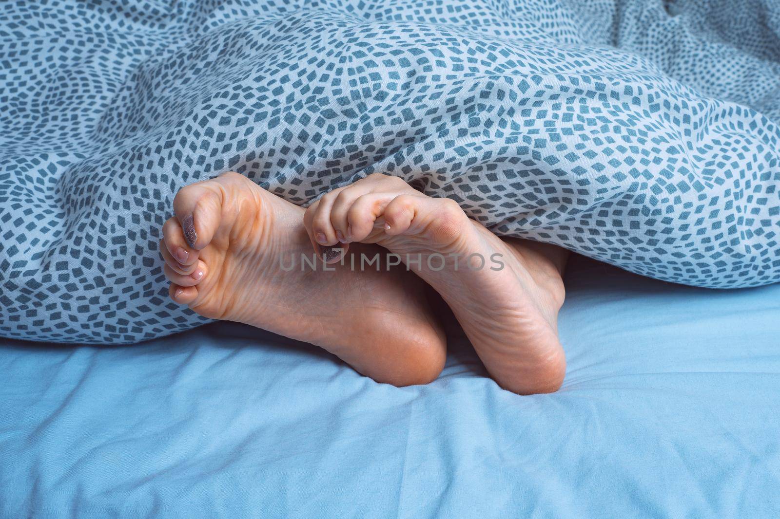 Foot cramps, leg cramps or muscular spasm. Foot pain or foot ache at night. High quality photo