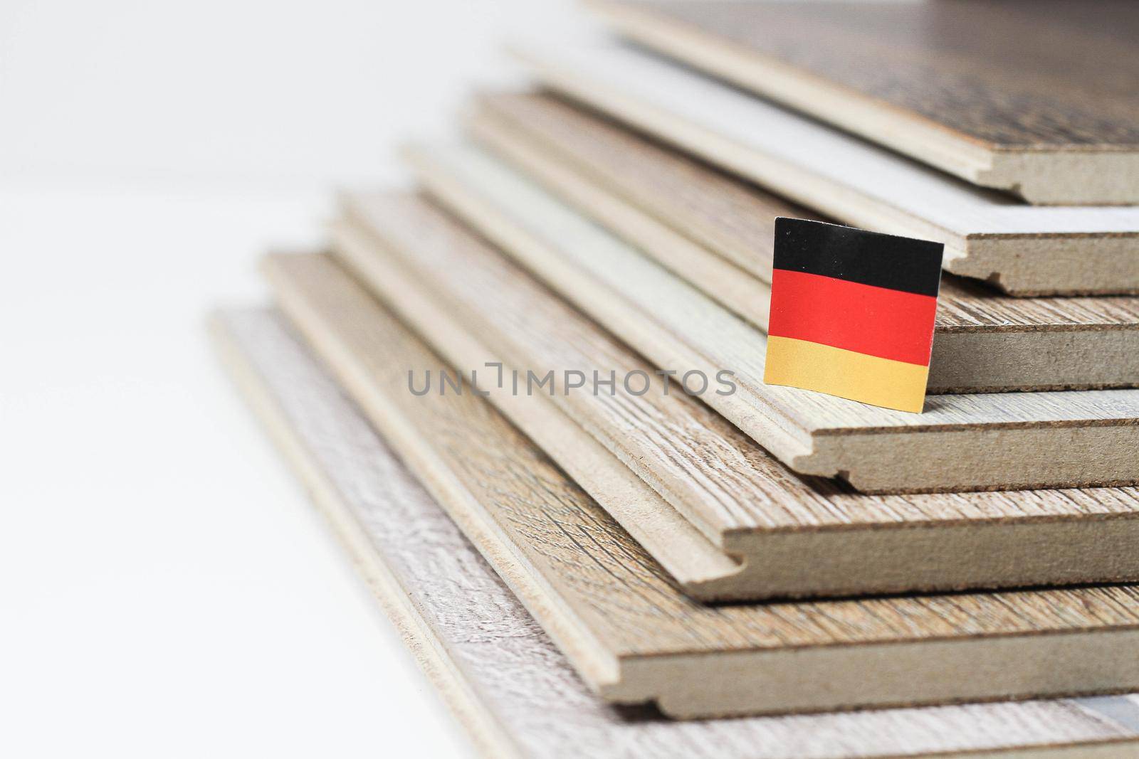 Laminate. Laminated boards. Laying laminate flooring. Floor coverings. German quality. Germany flag on laminate flooring. Quality assurance. Durable floor coverings.