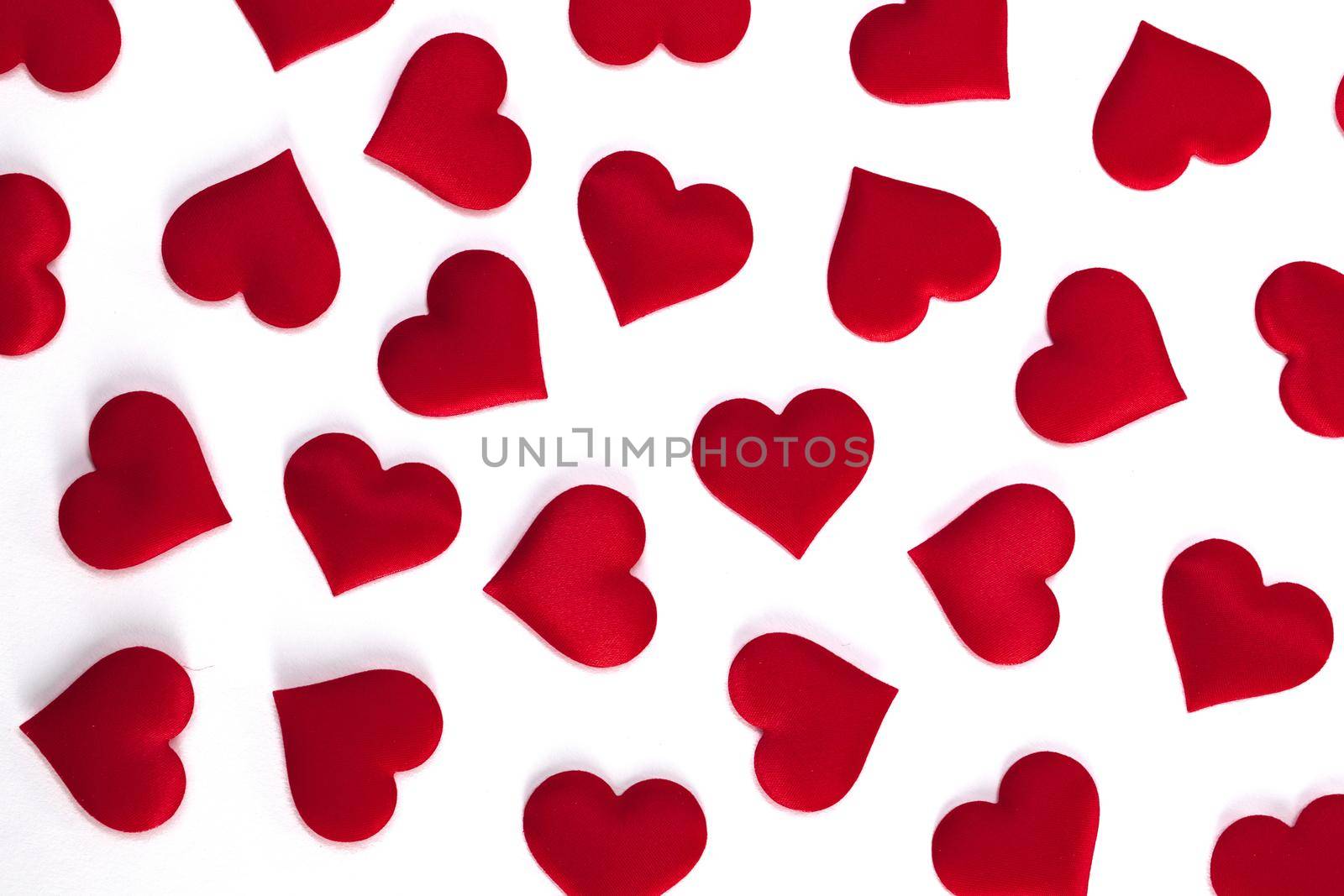 Valentines day many red silk hearts on white background, love gift pattern concept