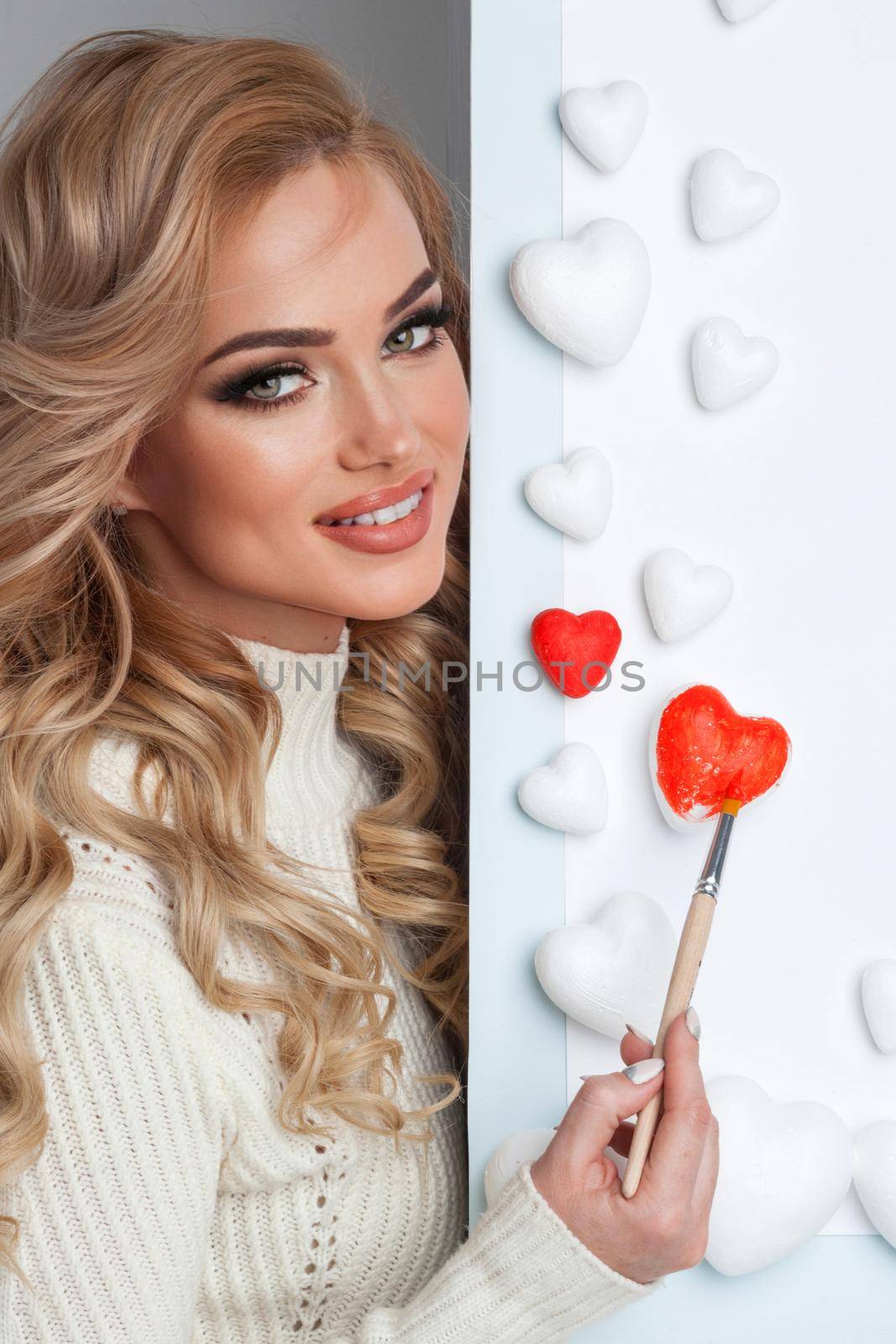 Woman painting red hearts by Yellowj