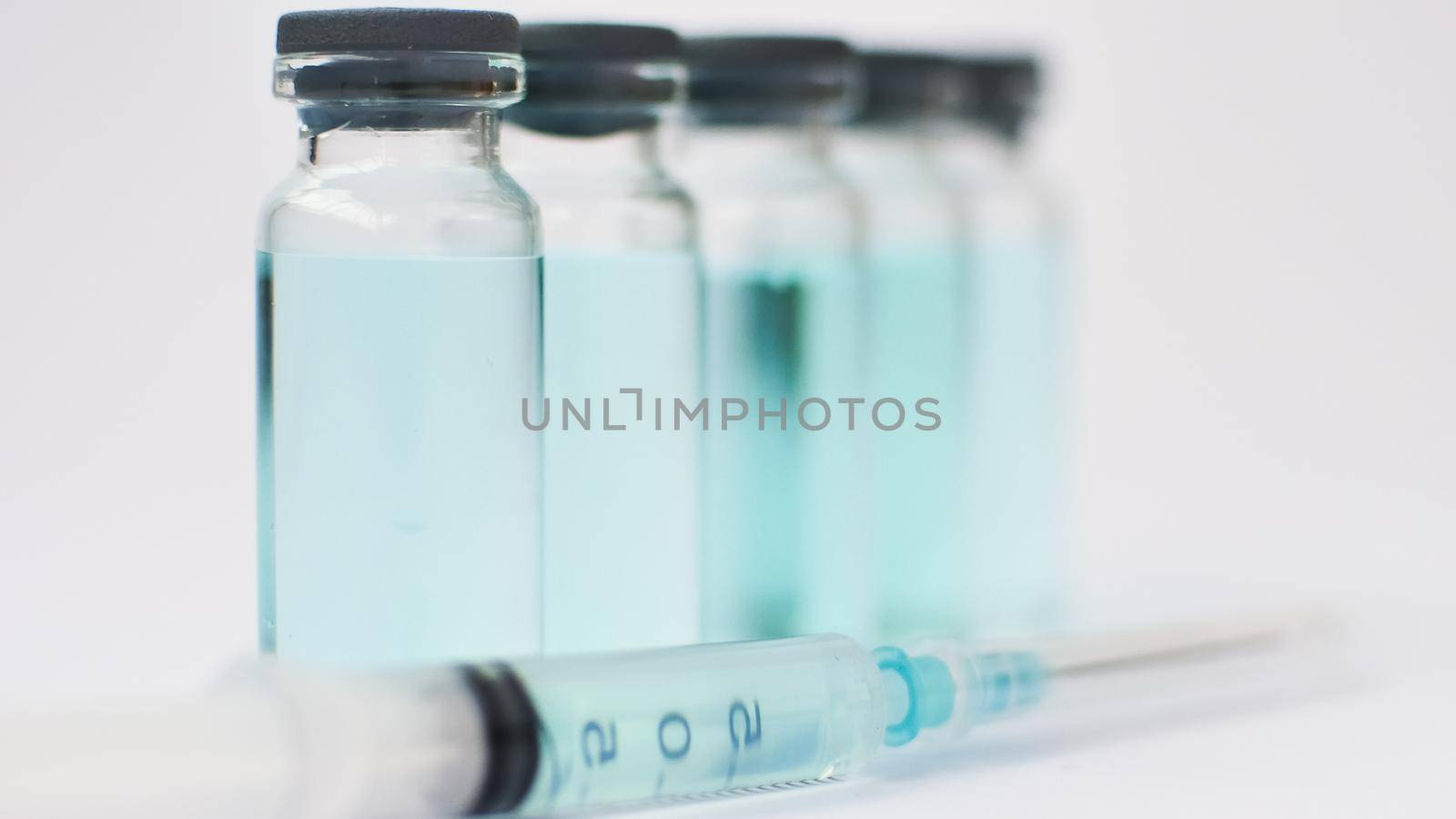 Medical ampoules and insulin syringe isolated on white background, vaccination concept.